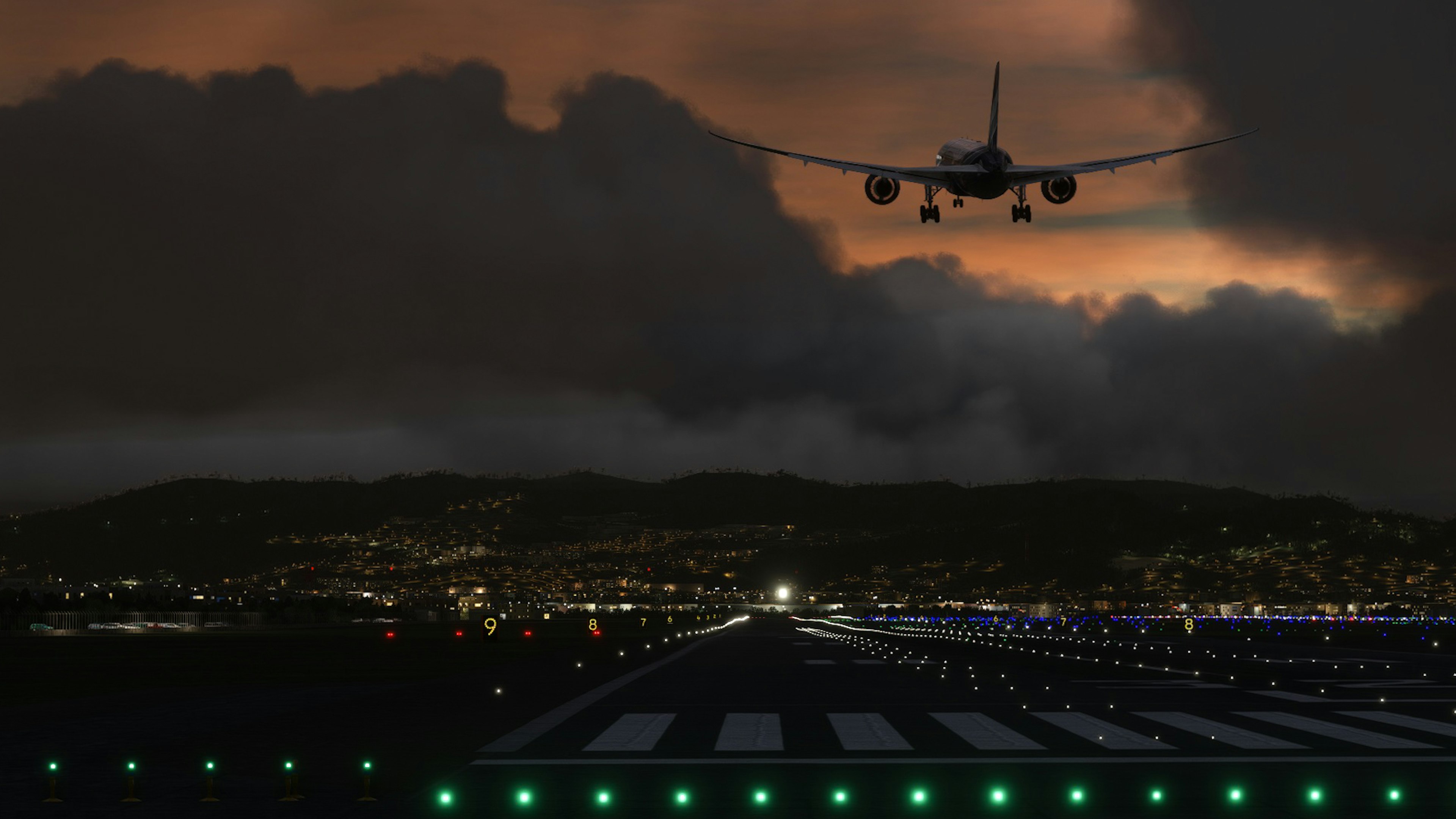 Airplane landing at night with city lights and runway lights visible