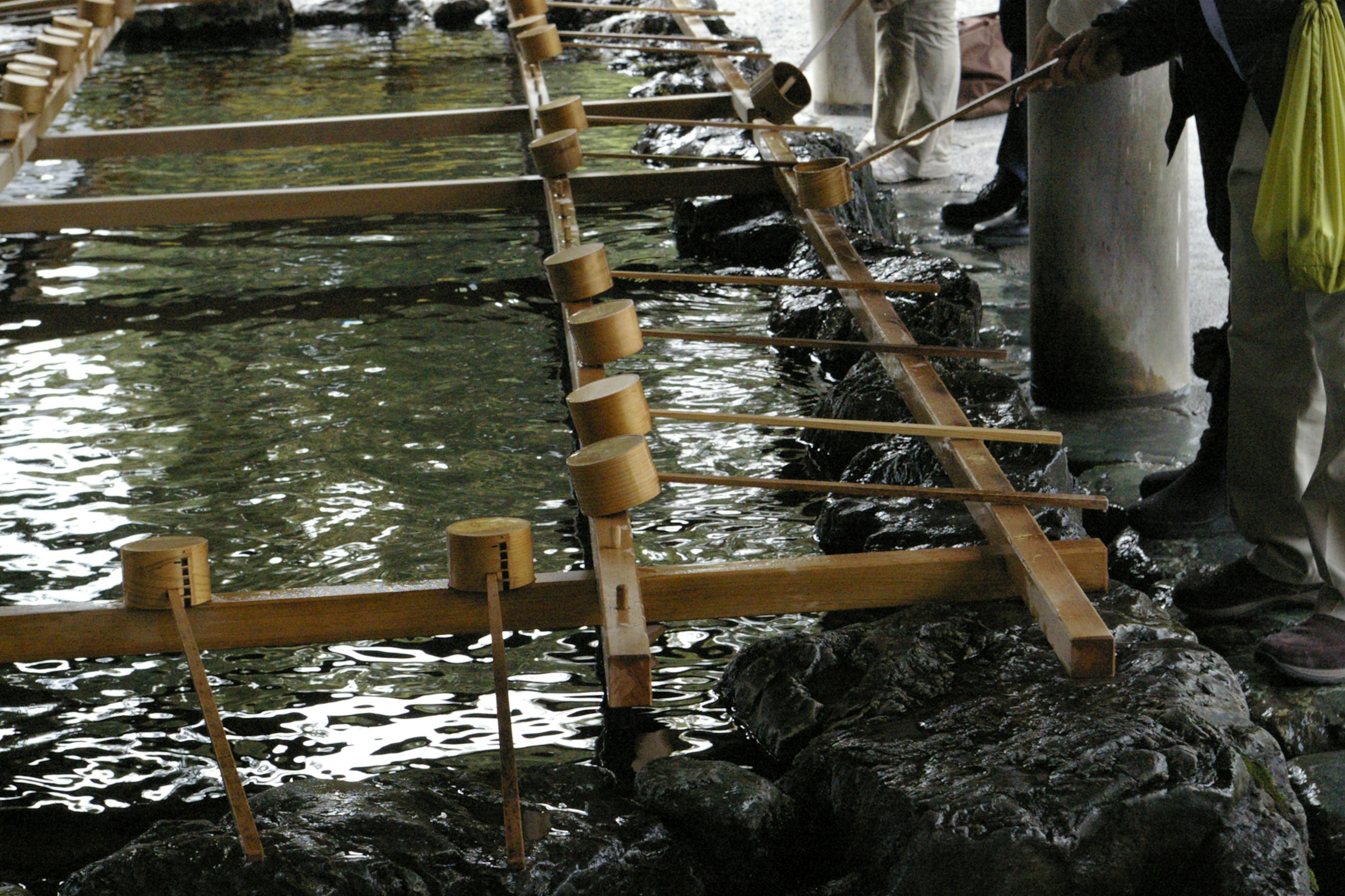 Wooden structure over water with people working nearby