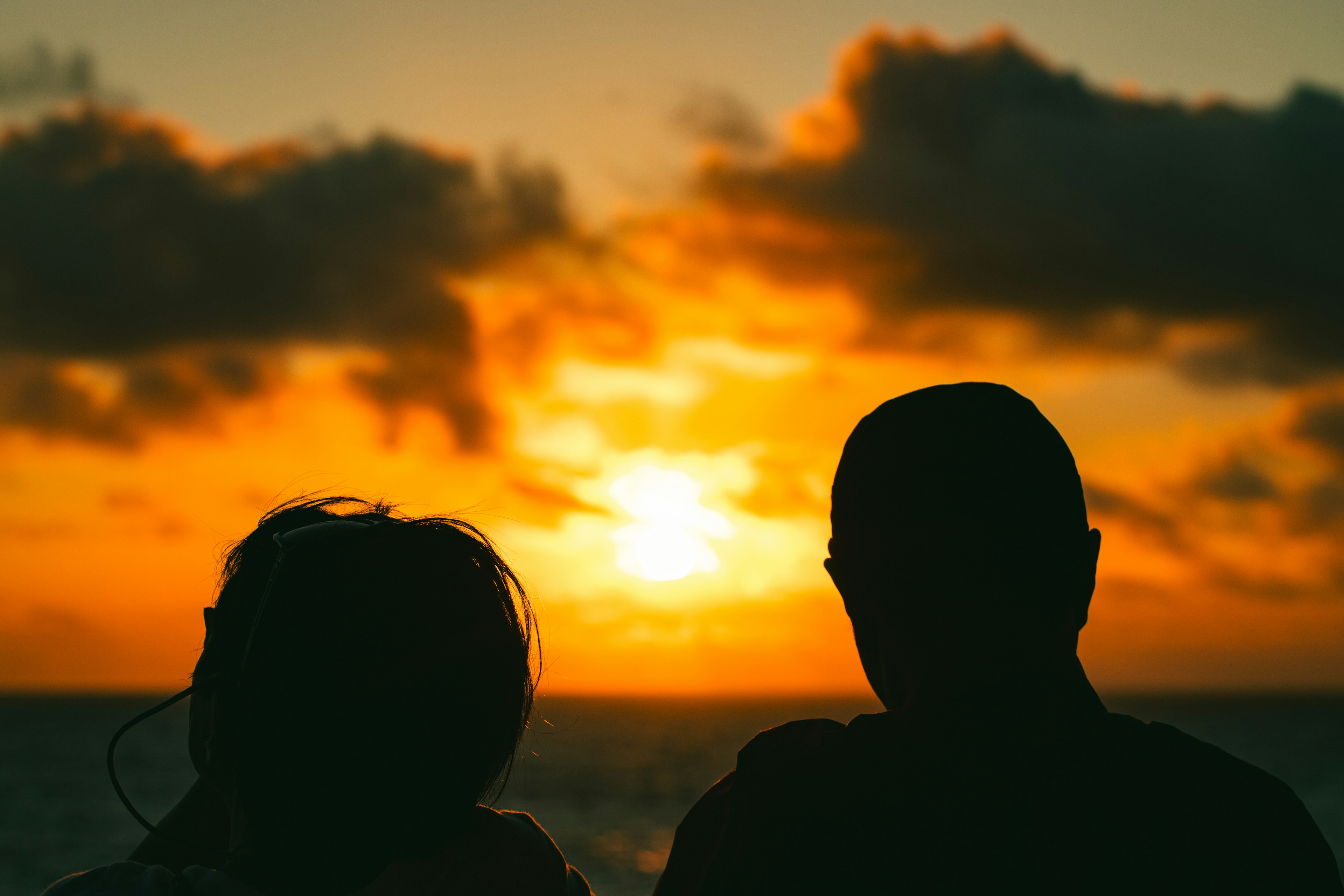 Silhouette of a couple gazing at the sunset