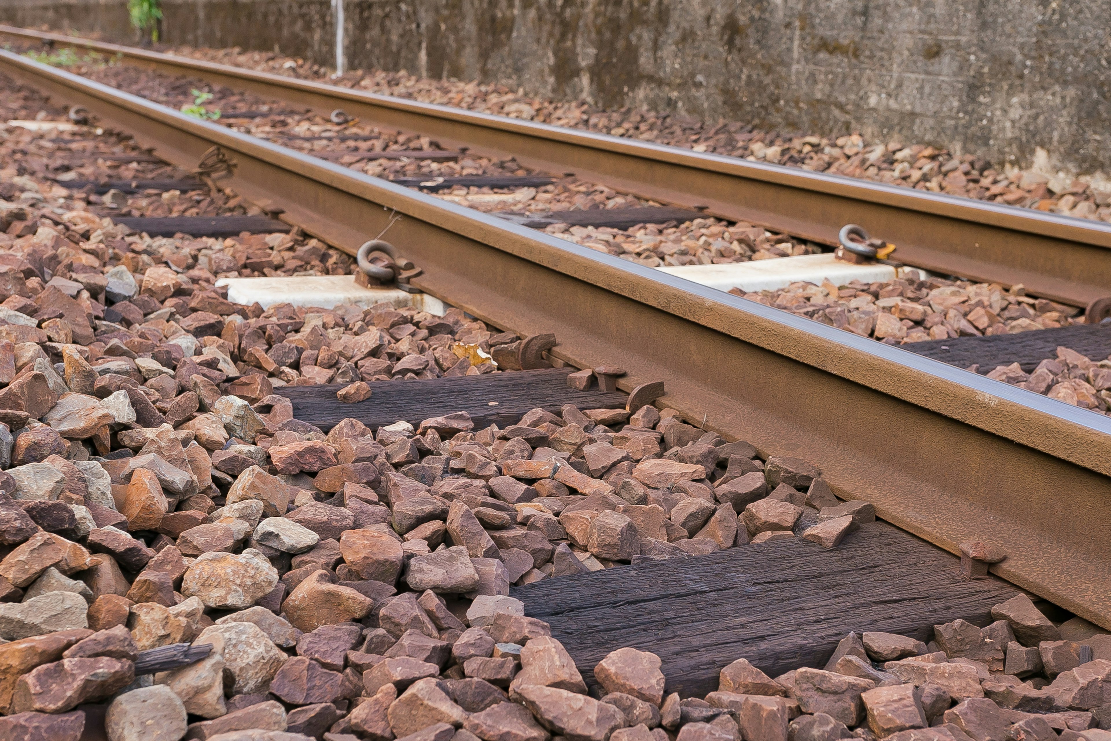 Close-up image of railway tracks and stone ballast