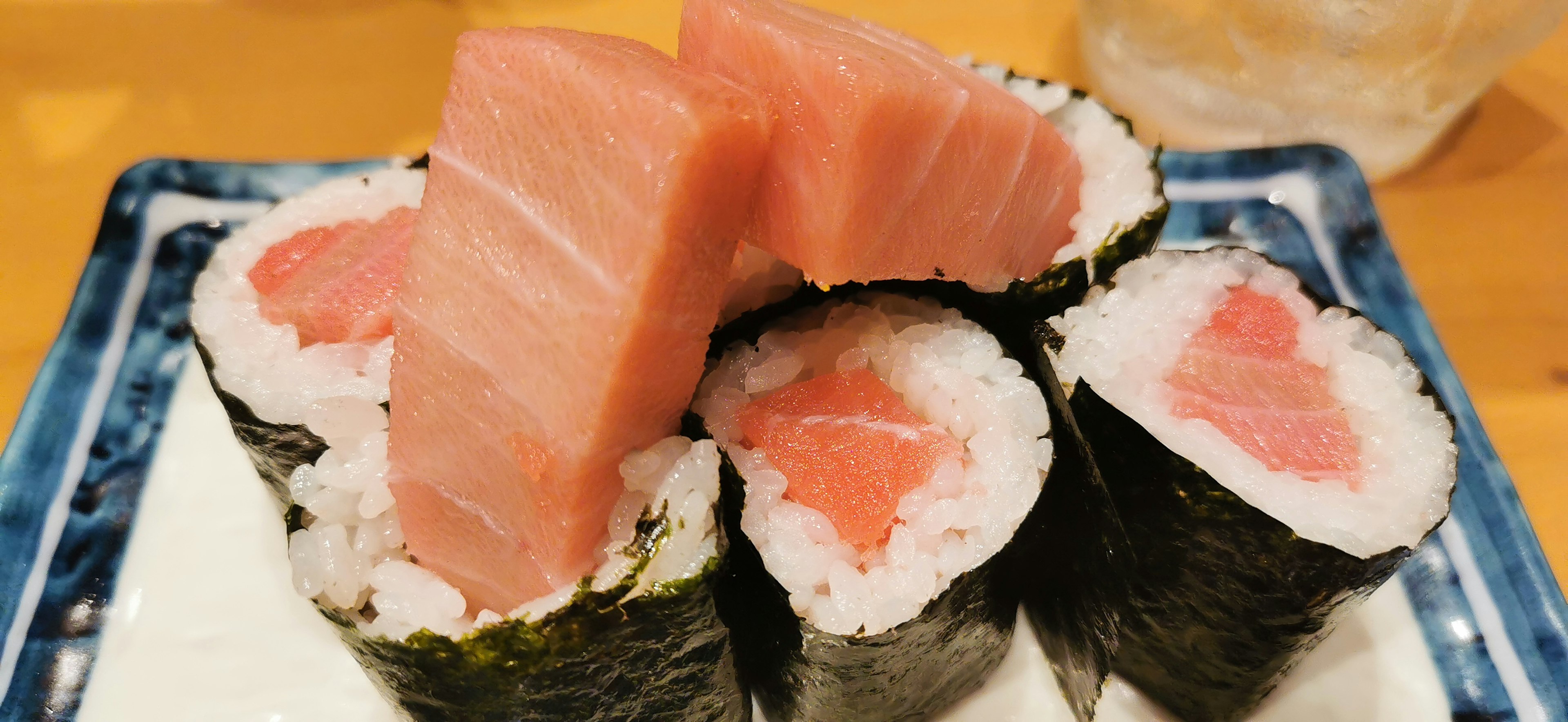 A plate of fresh tuna sushi with sliced pieces on top