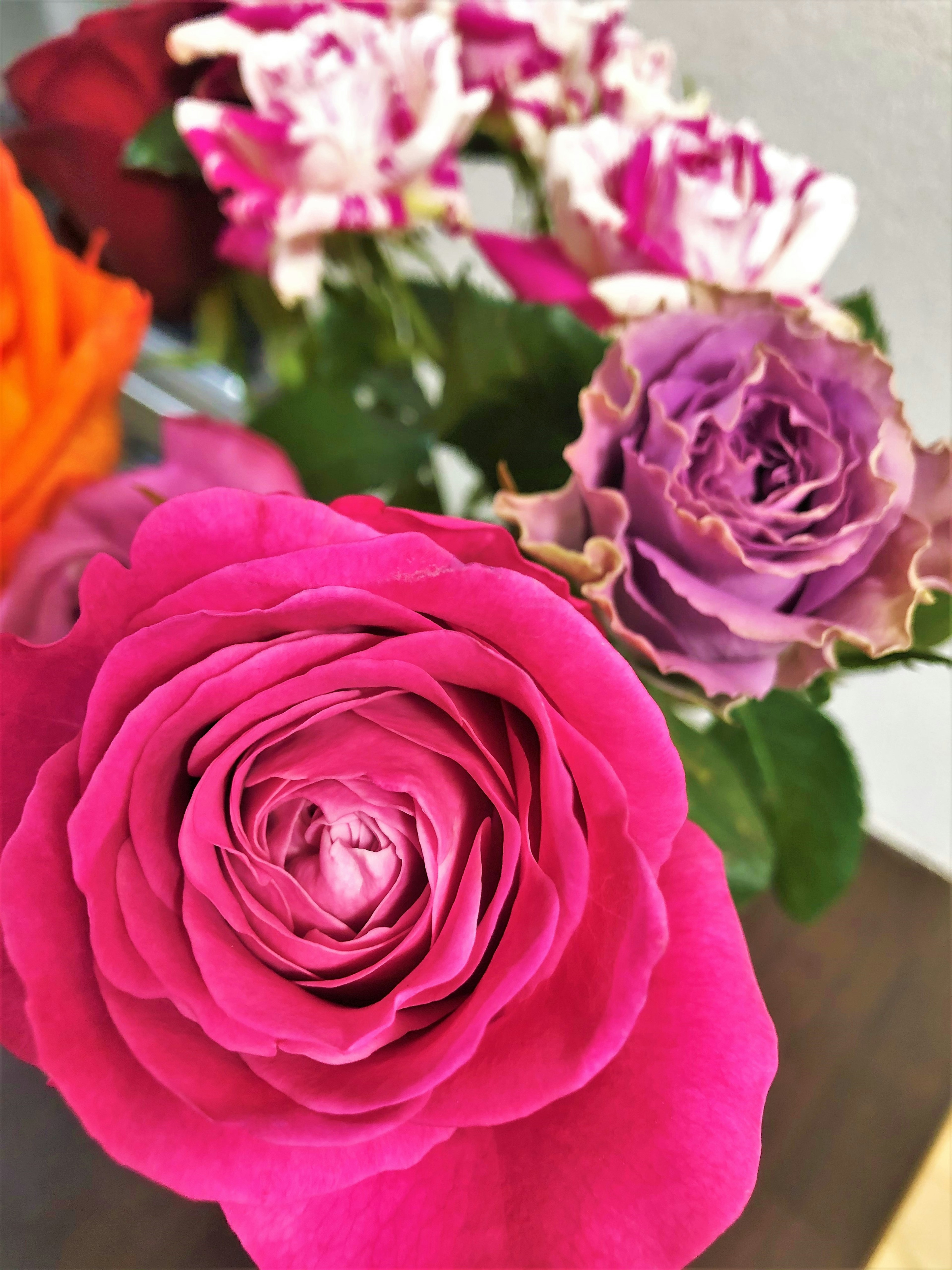 A bouquet featuring vibrant pink and purple roses