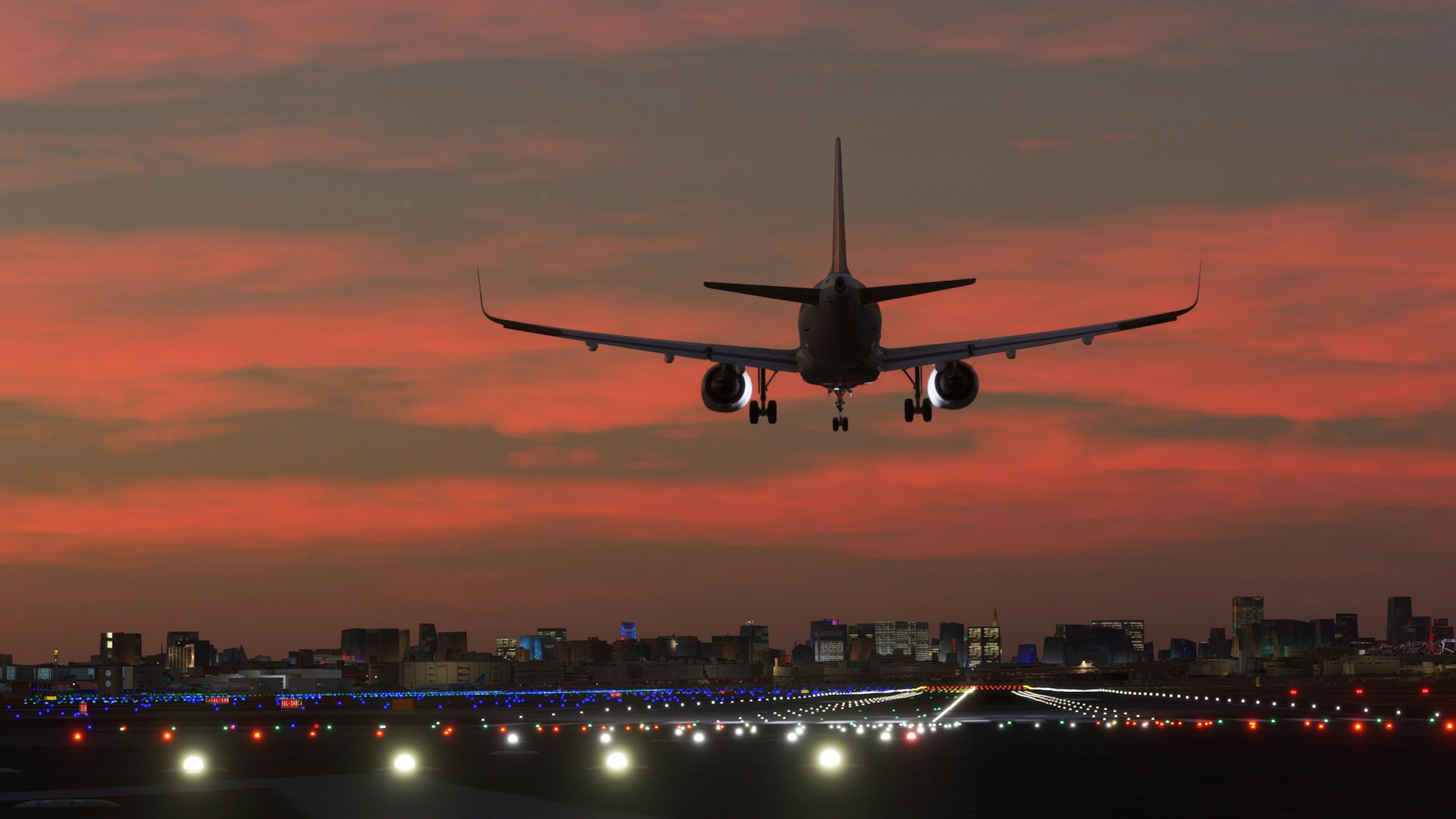 Airplane landing against a sunset sky