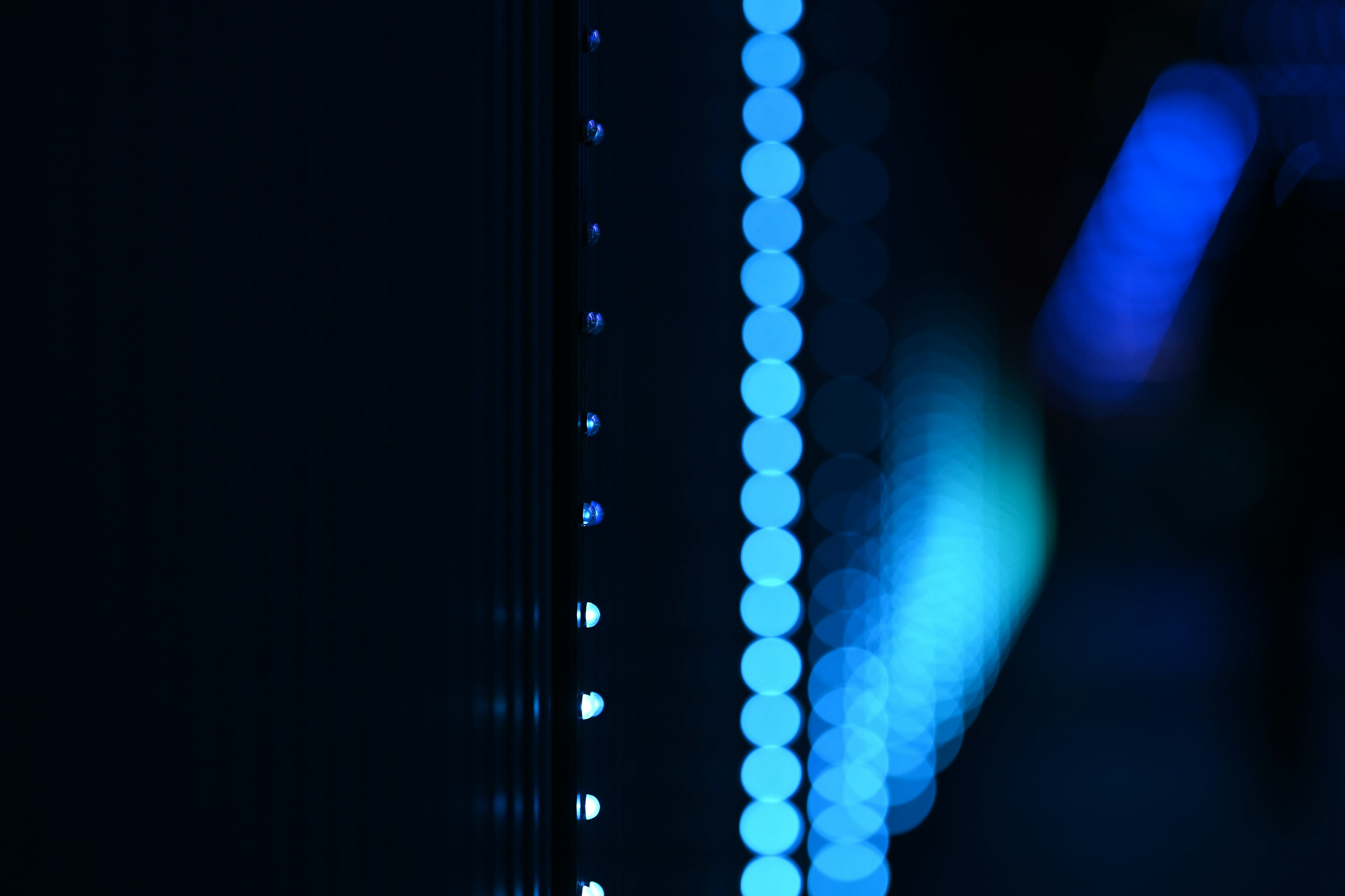 Image featuring a series of blue light dots against a dark background