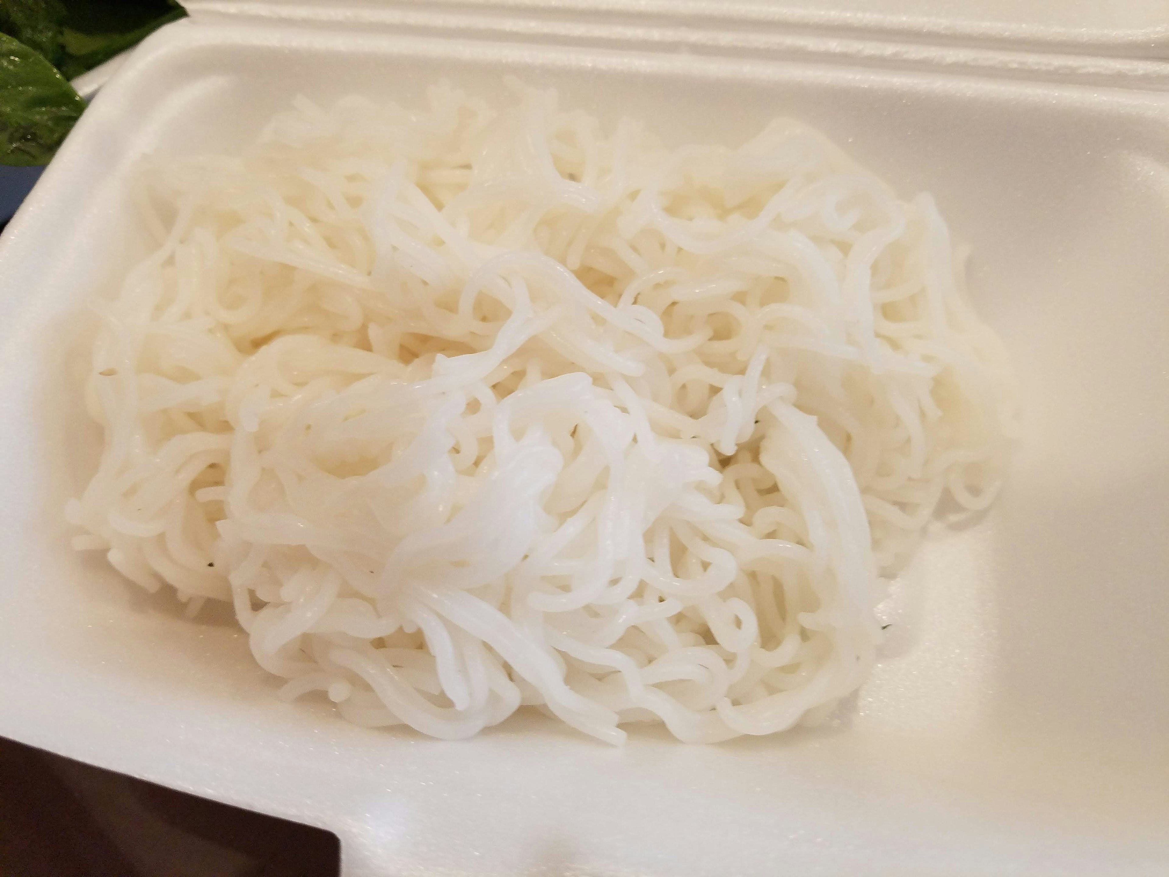 White rice noodles piled in a container