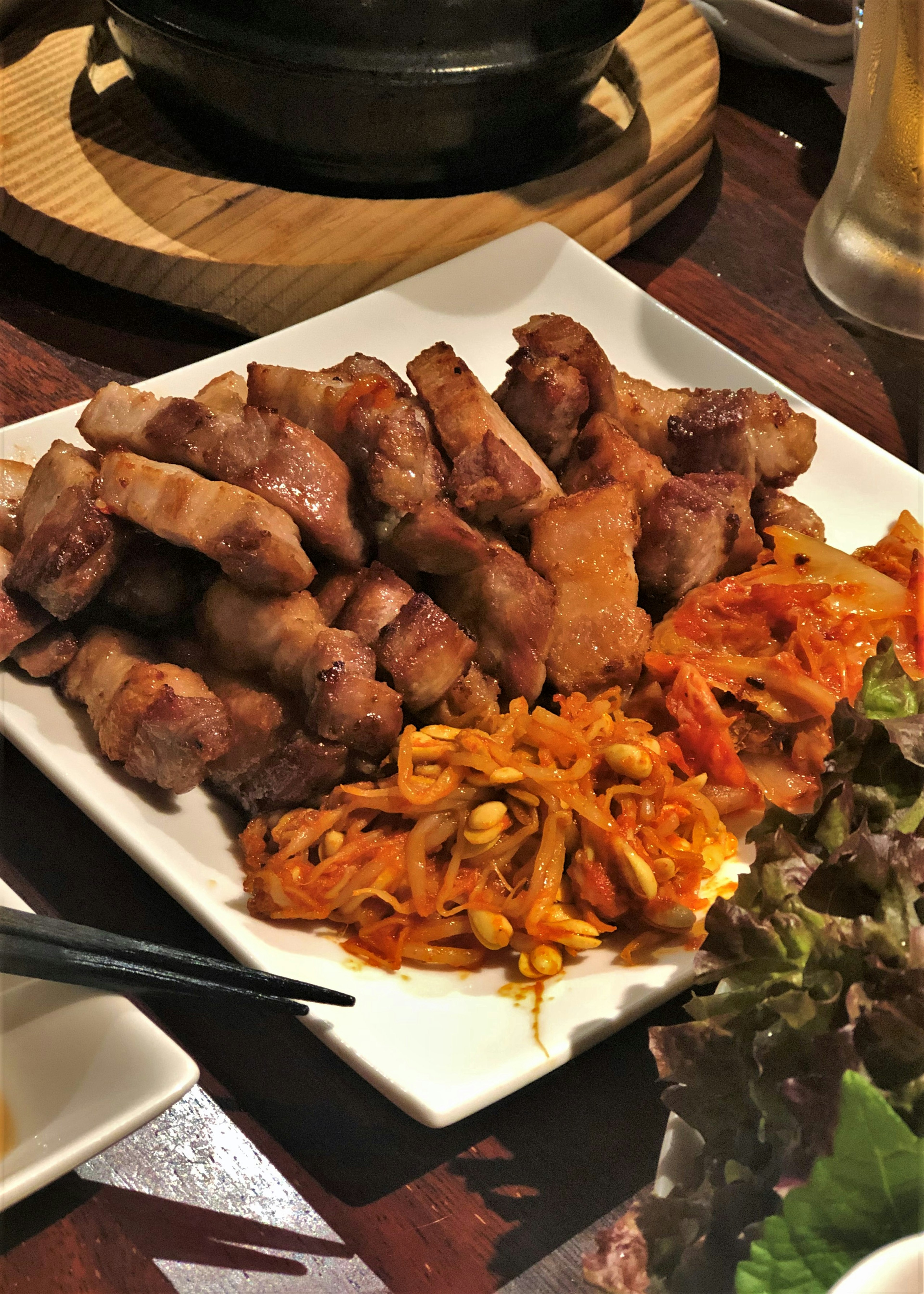 Platter of grilled meat with kimchi and vegetables