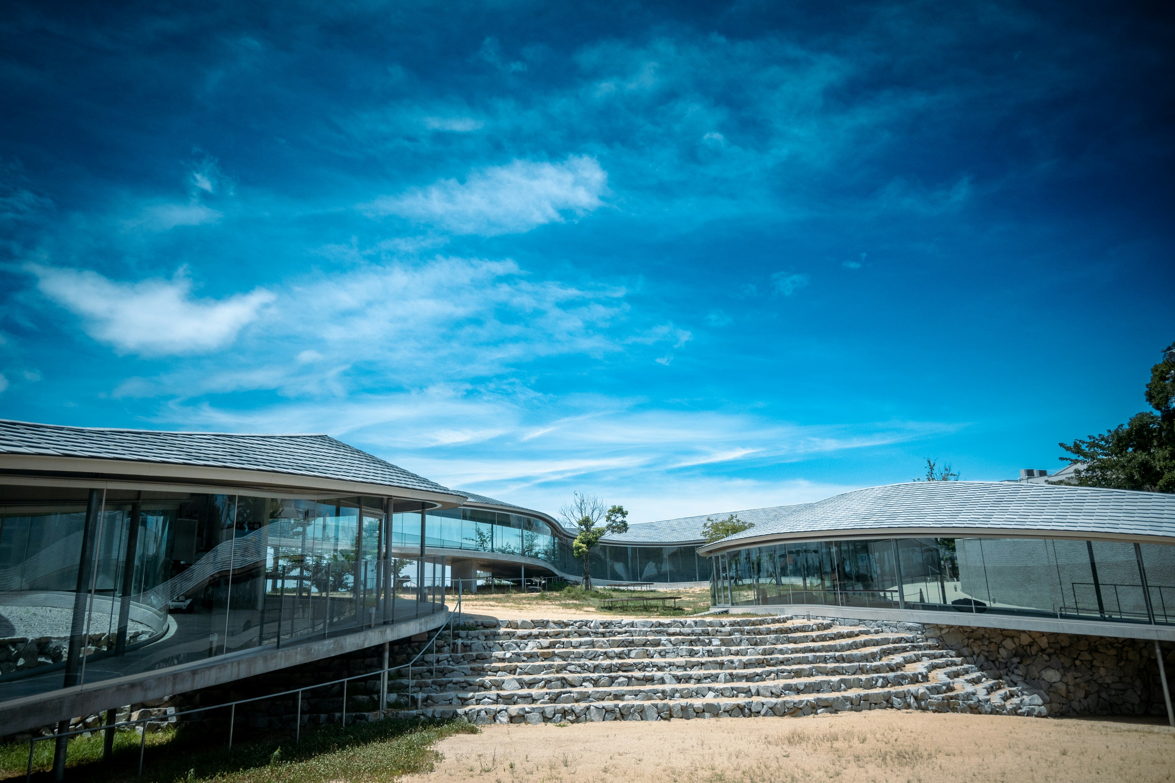 Arquitectura moderna bajo un cielo azul con escaleras de piedra