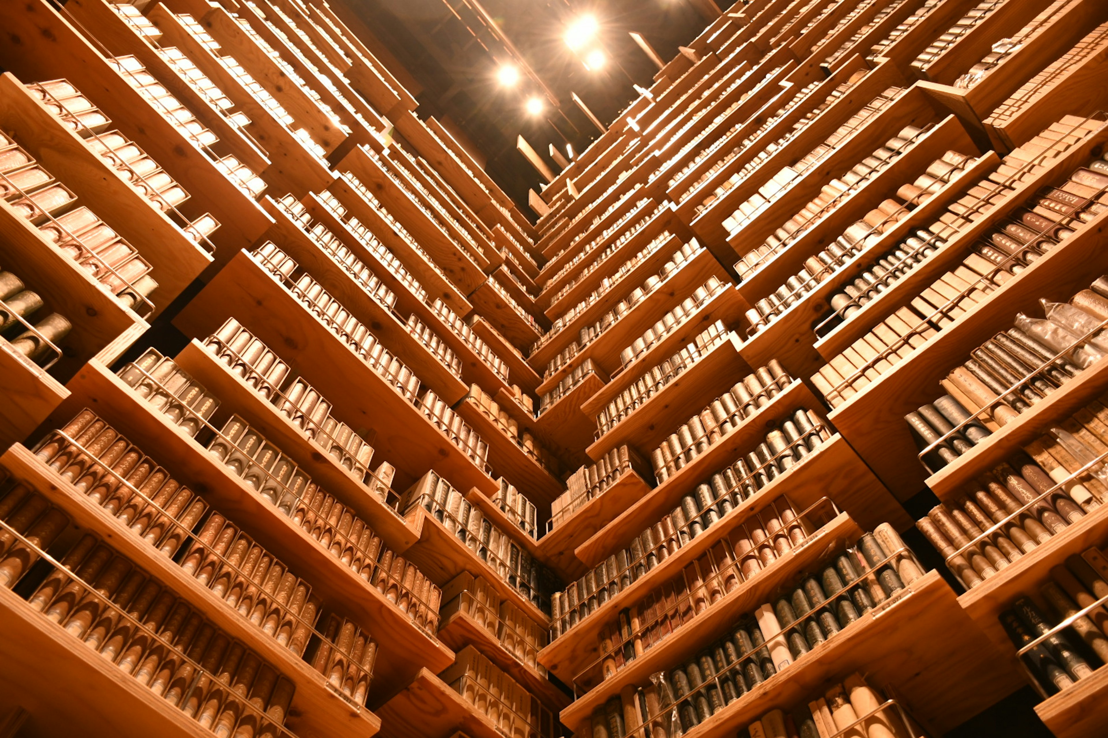 Interior of a library with towering wooden bookshelves