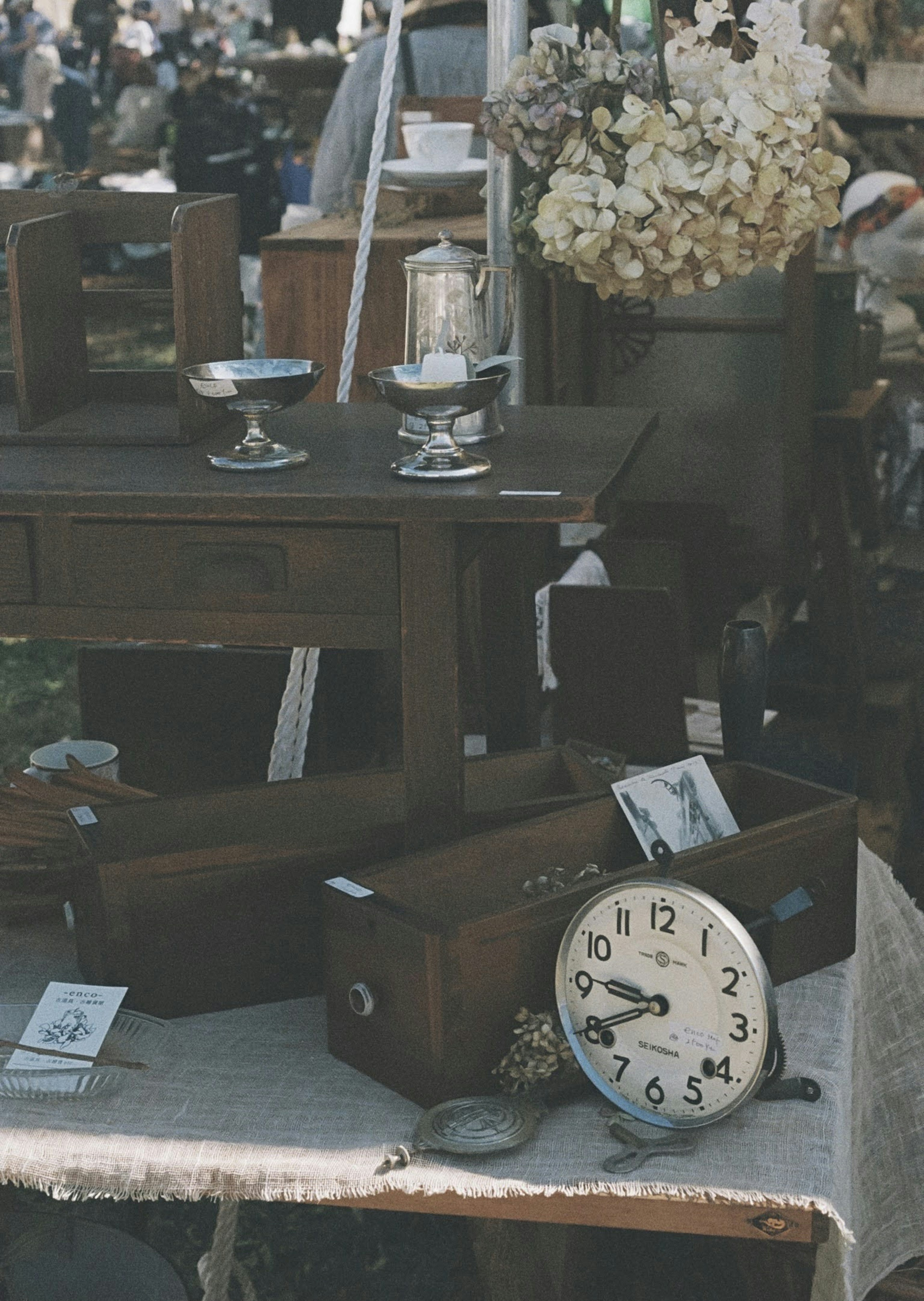 A market scene featuring vintage wooden furniture and an antique clock