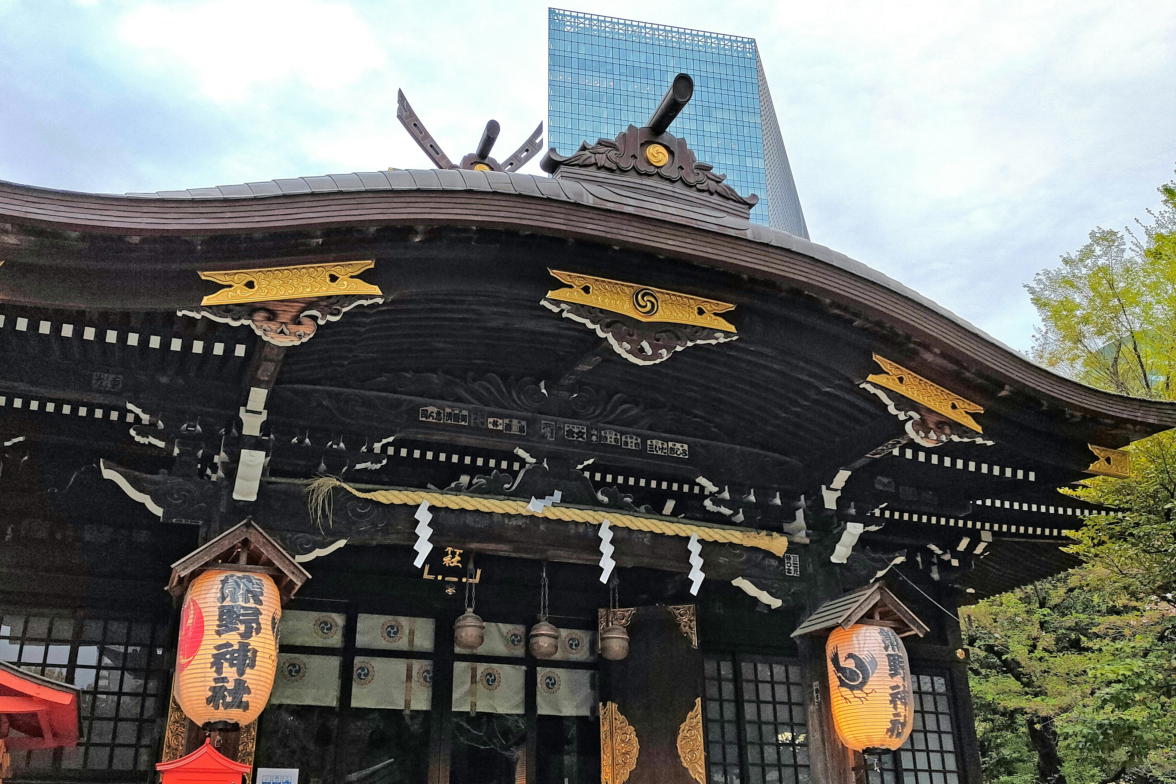 Traditional shrine architecture contrasted with a modern building