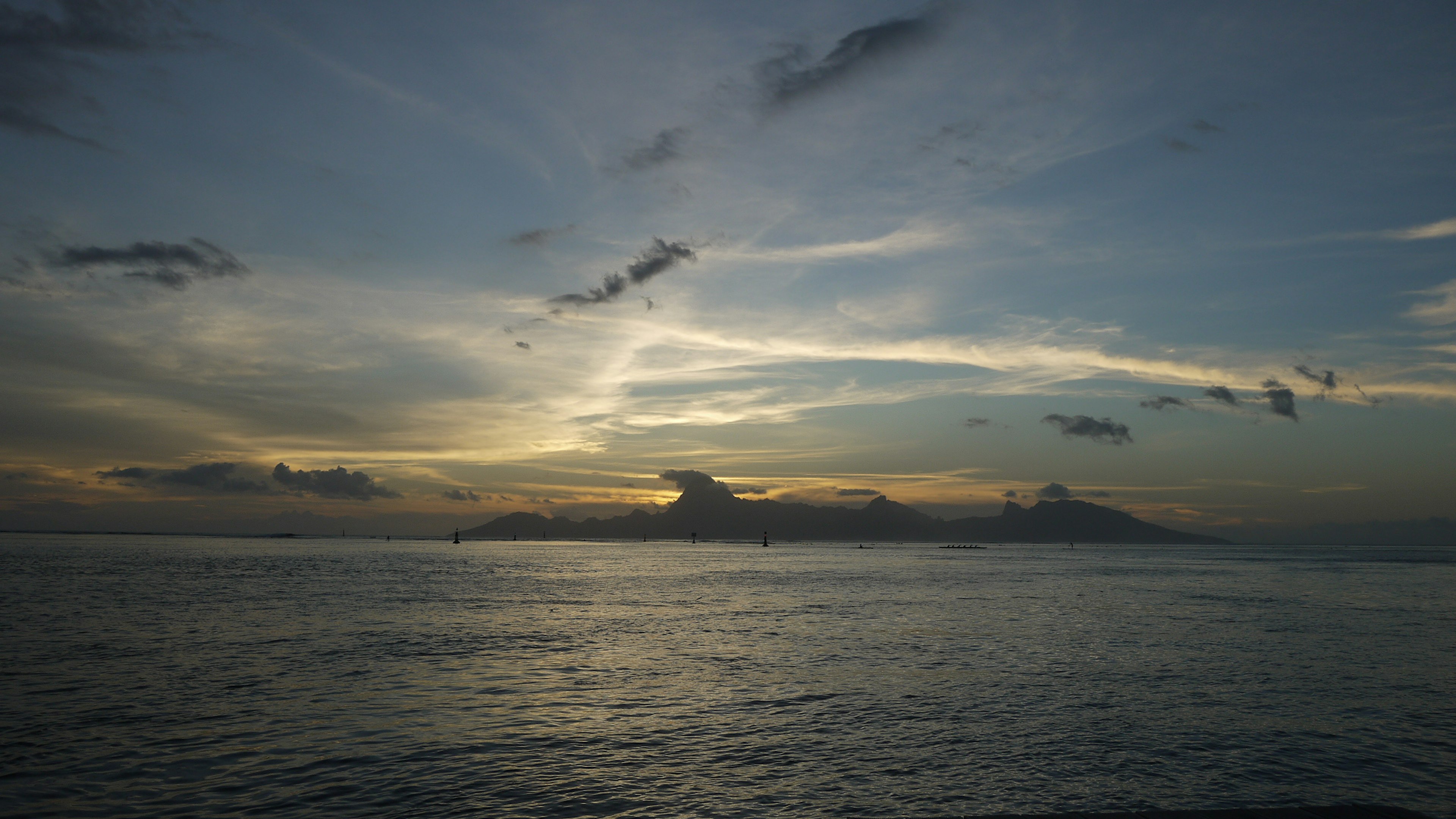 Beautiful sunset over the ocean with silhouettes of clouds