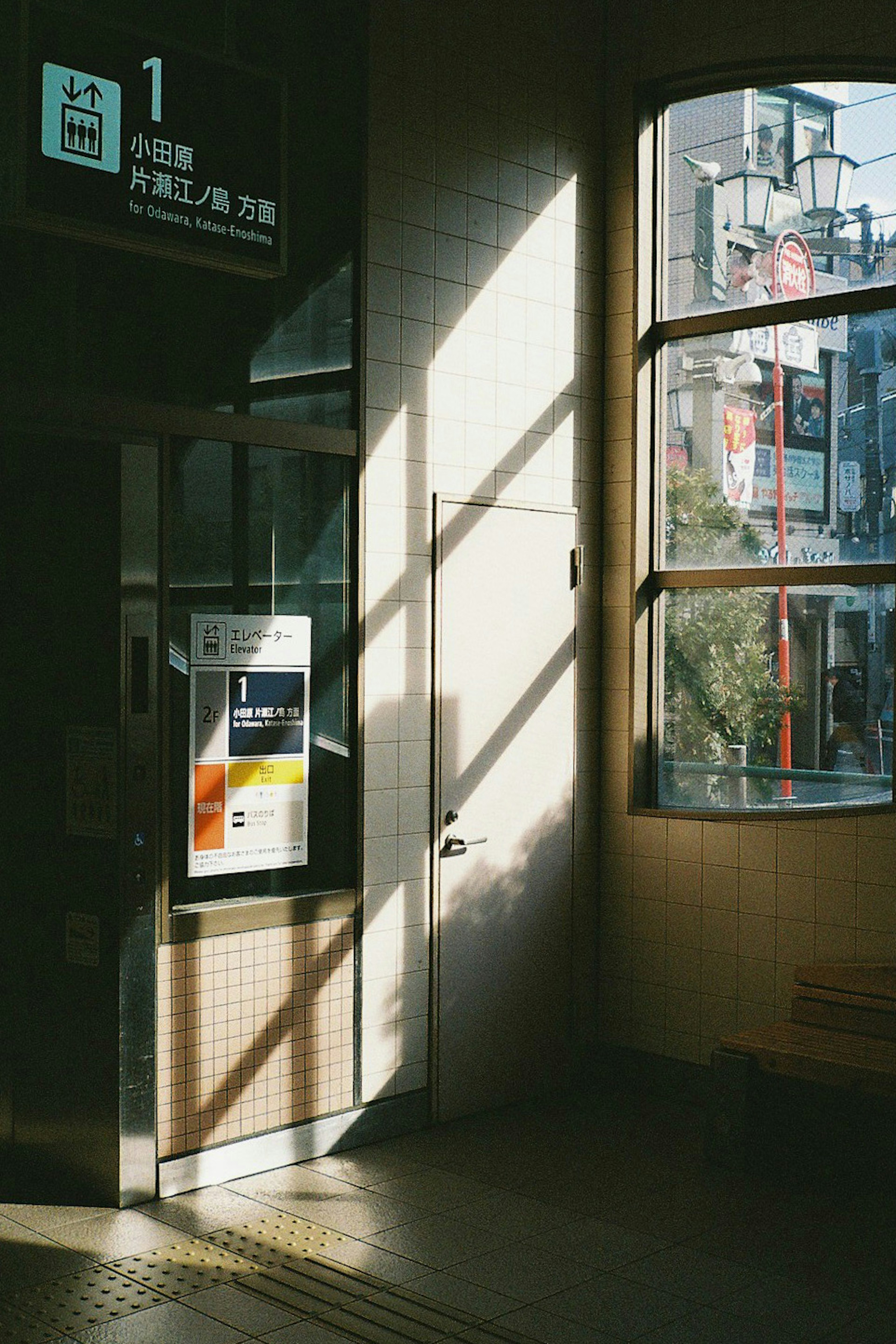 Train station ticket gate with sunlight streaming through the window