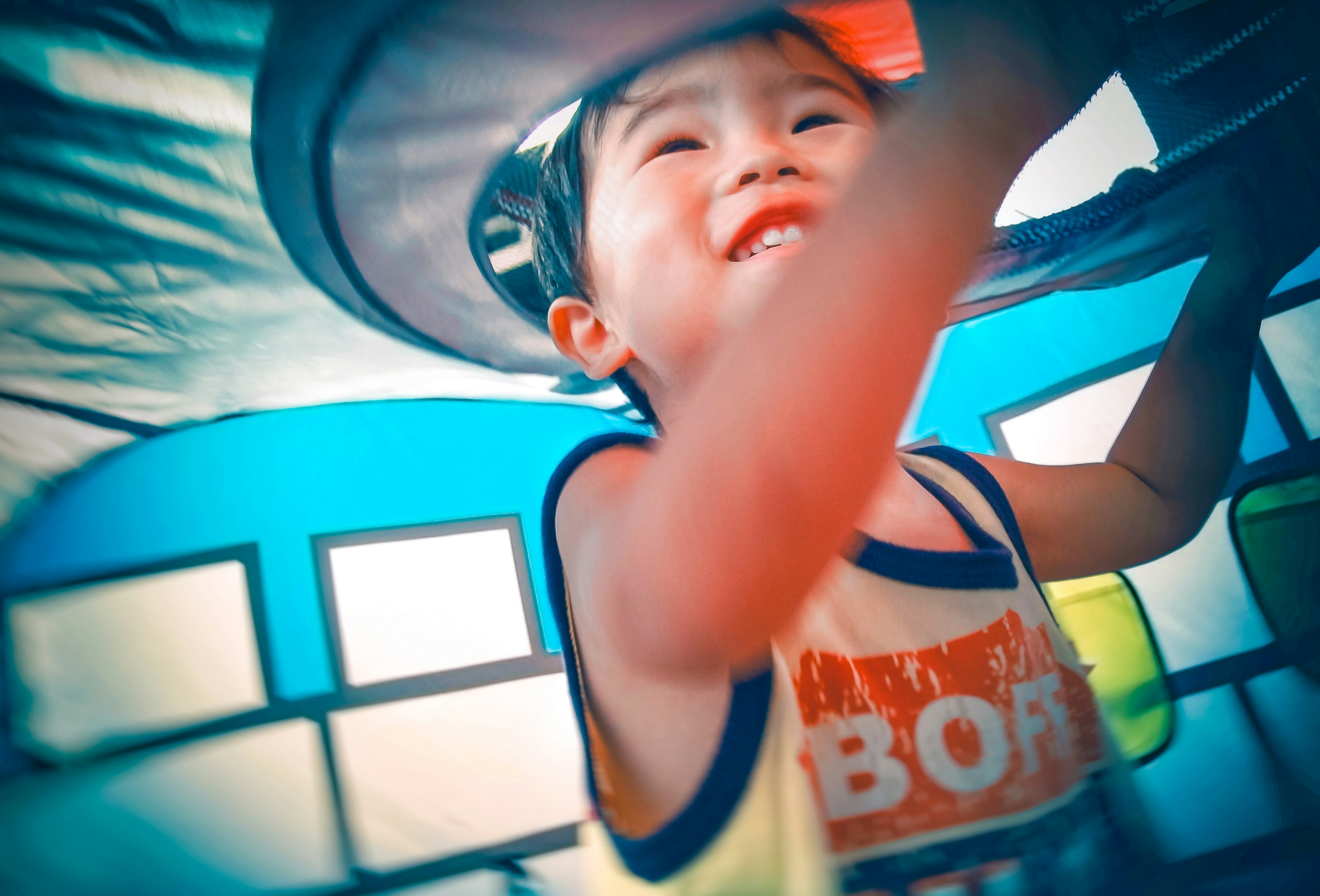 Child playing inside a play structure joyful expression