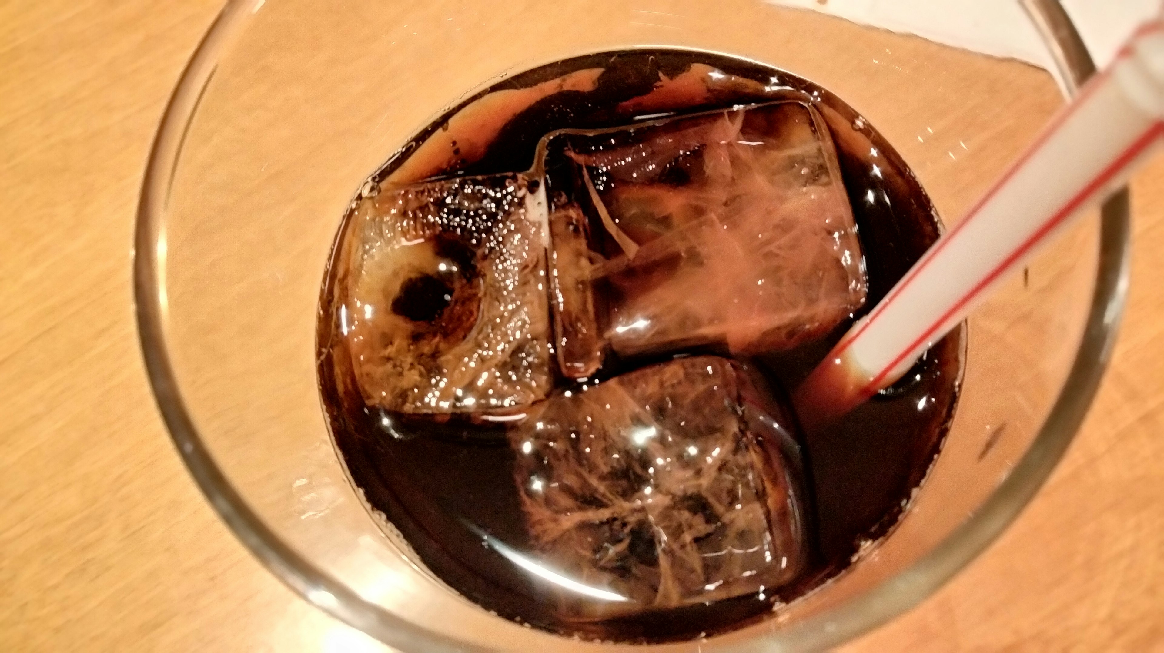 Close-up of a drink with ice cubes in cola