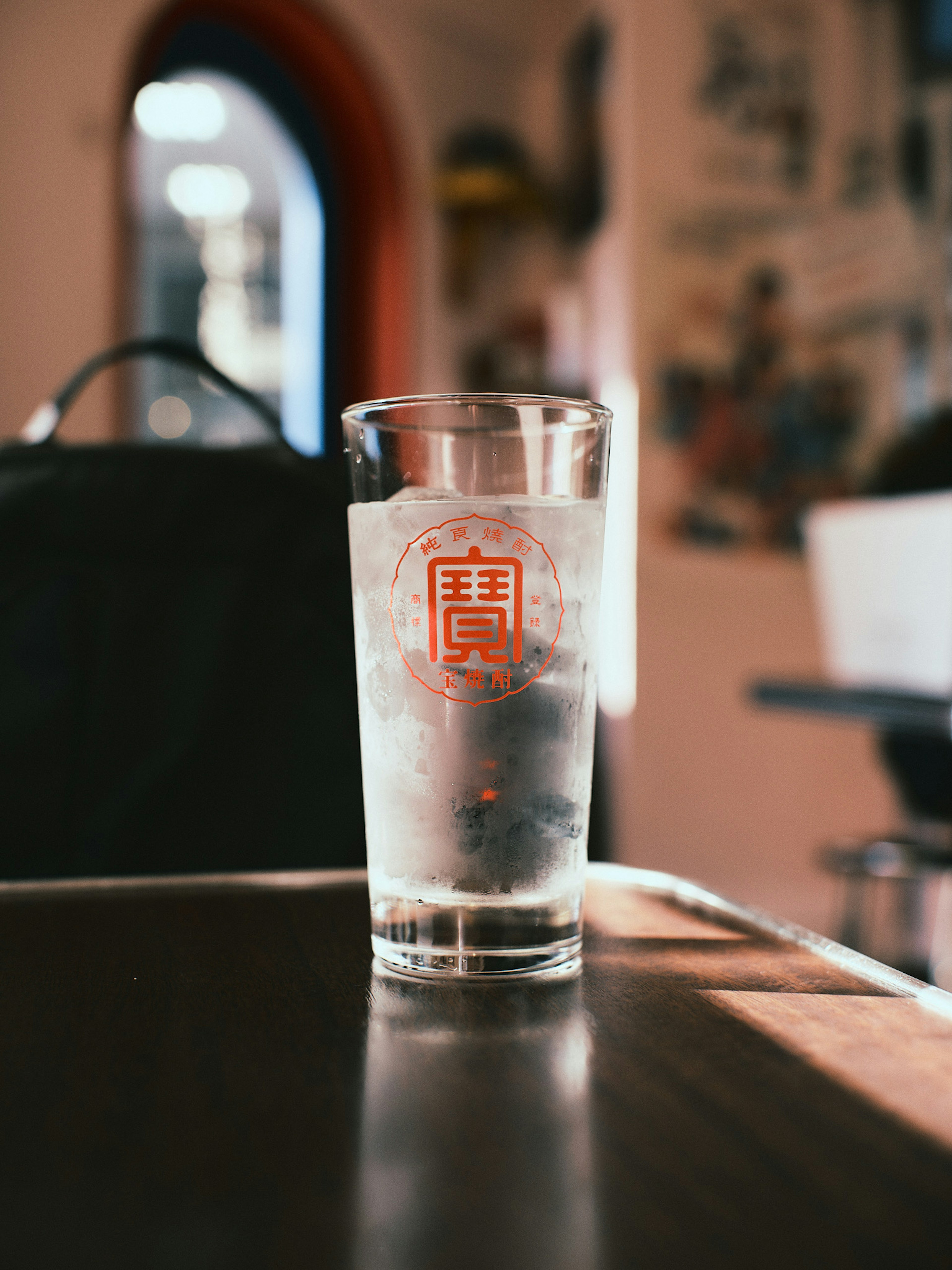 Clear glass with water and red logo design