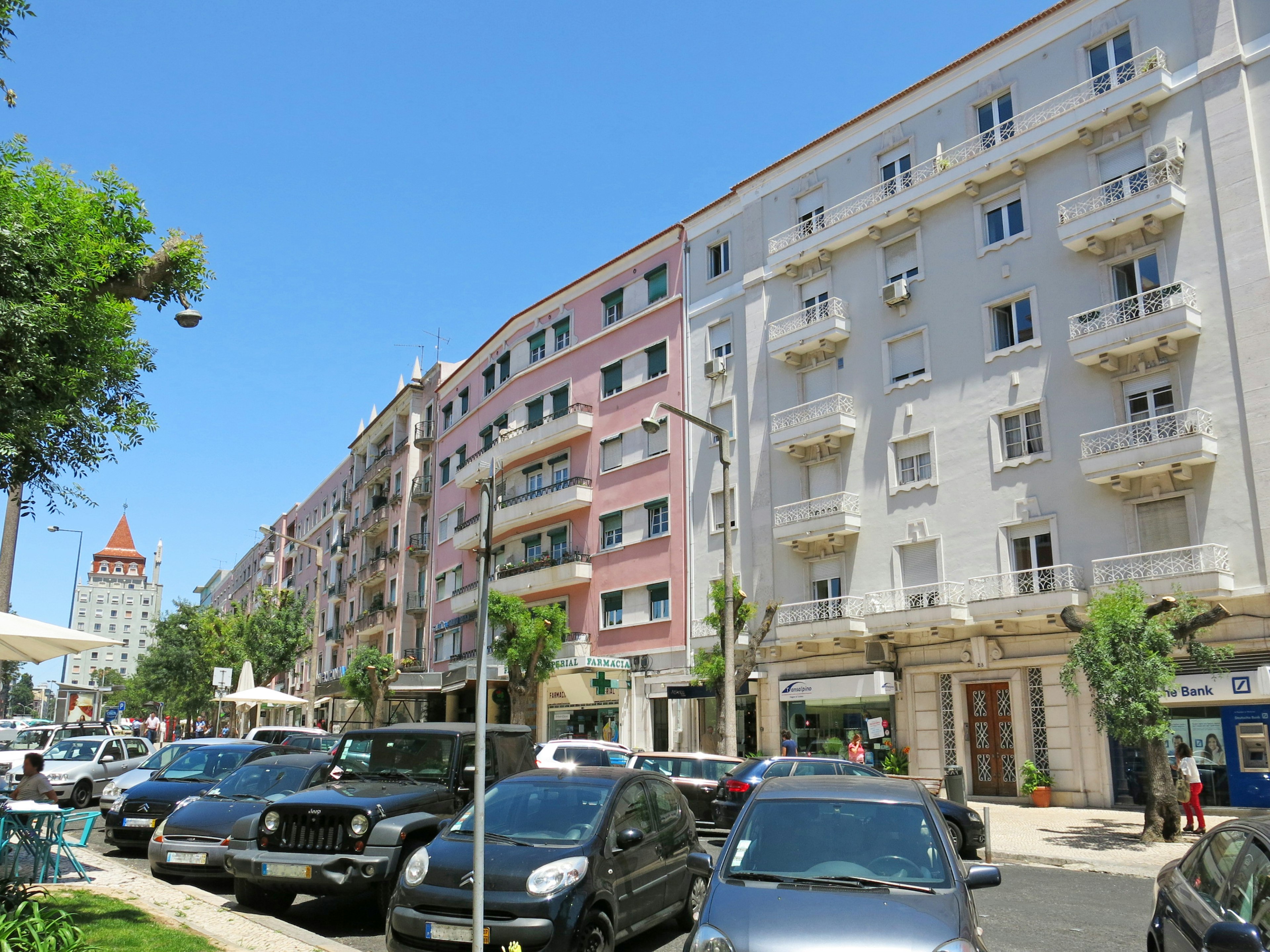 Street view featuring colorful buildings and parked cars