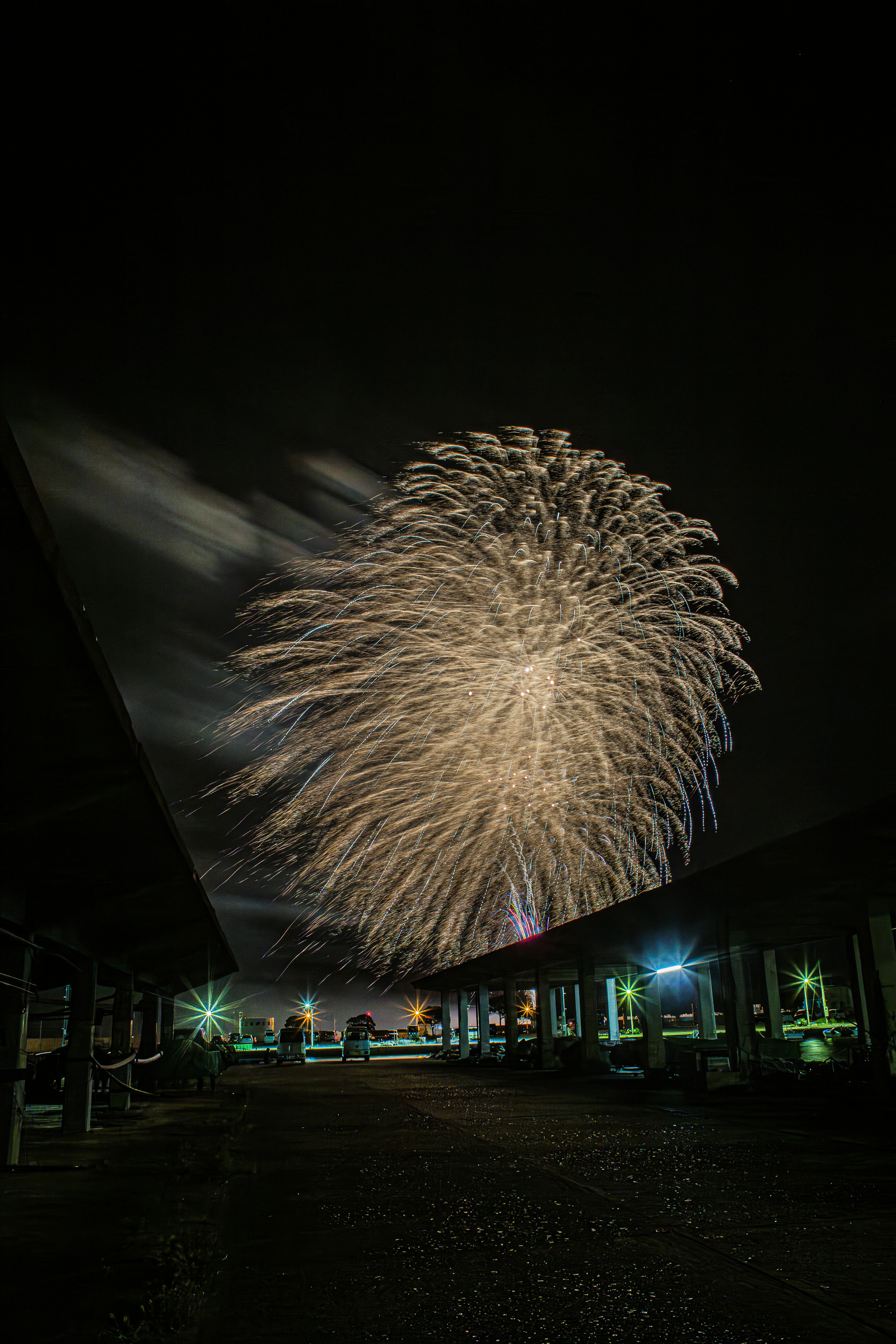 Beeindruckendes Feuerwerk, das den Nachthimmel mit umliegenden Lichtern erhellt