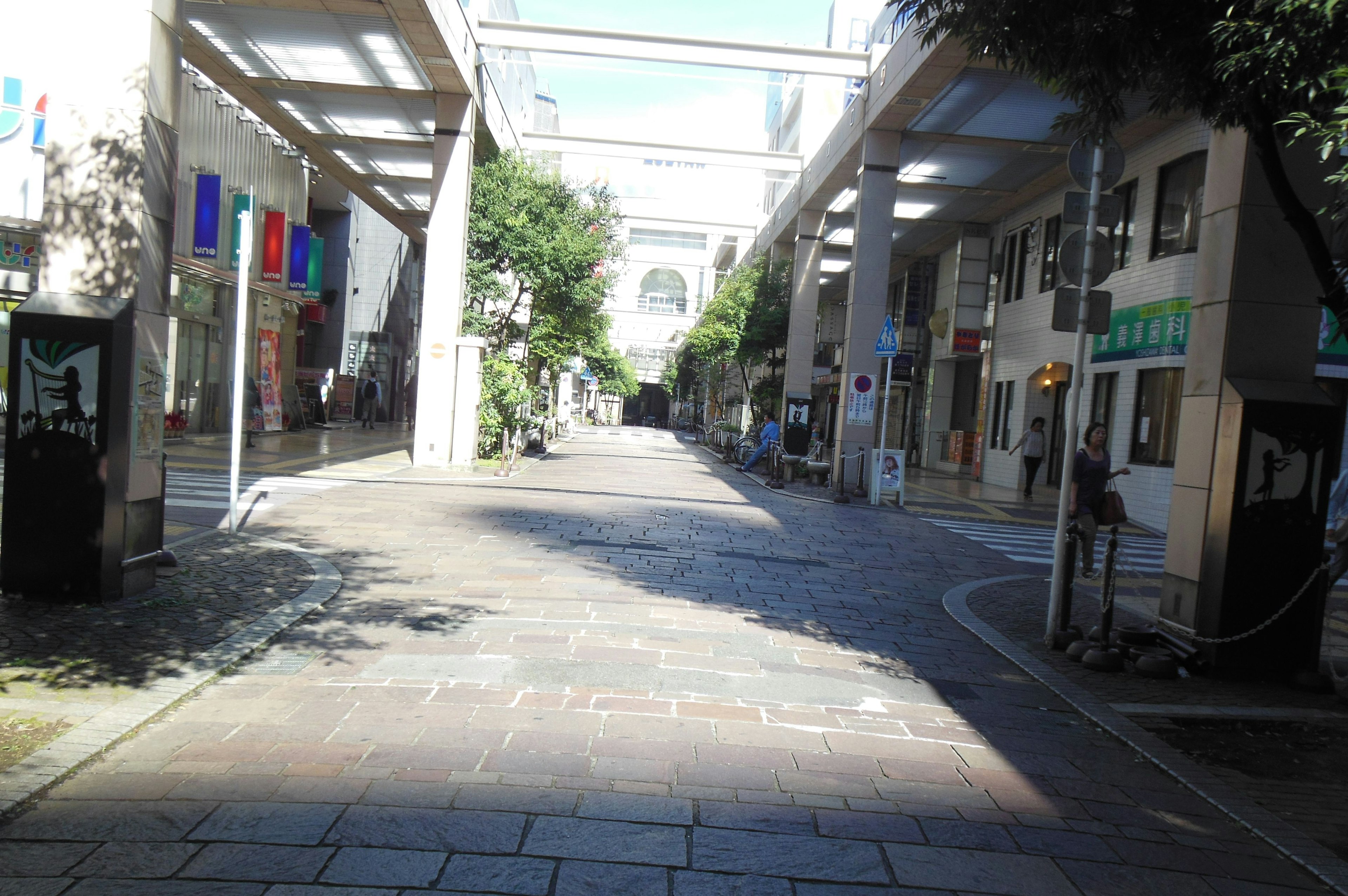 Quiet shopping street with sunlight streaming through