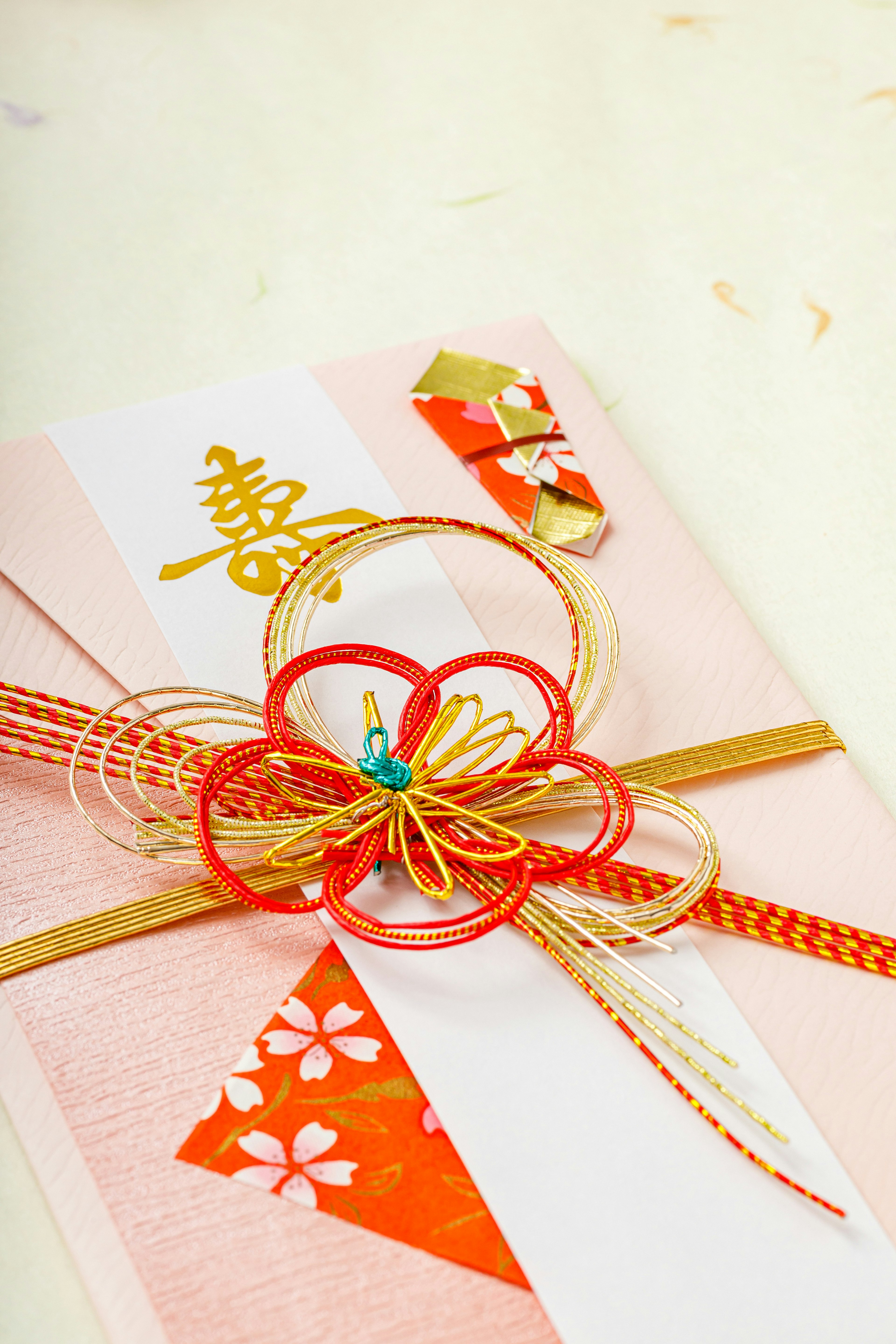 Japanese envelope adorned with a beautiful flower decoration and red ribbon