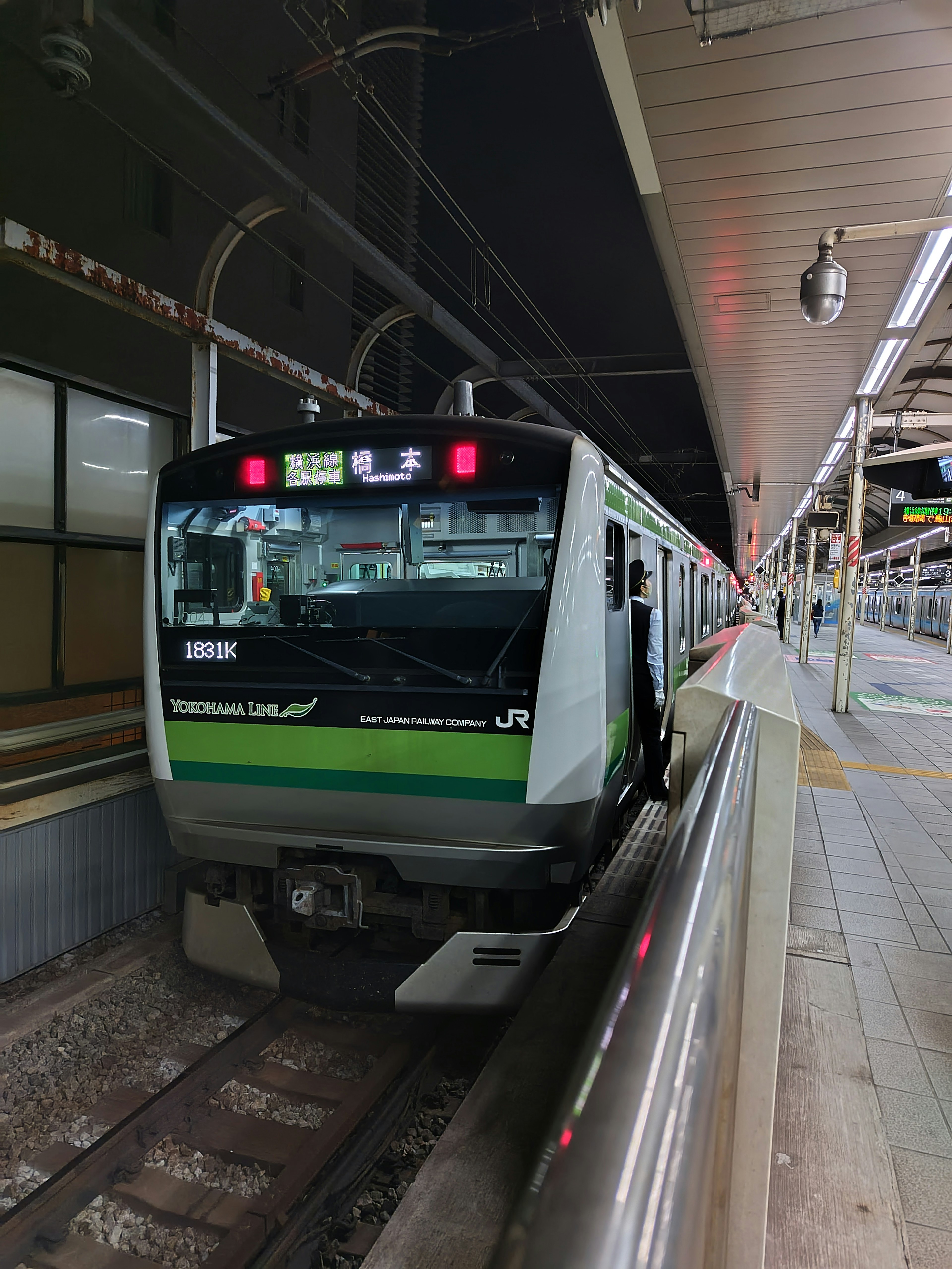 JR train stopped at a station with visible signage