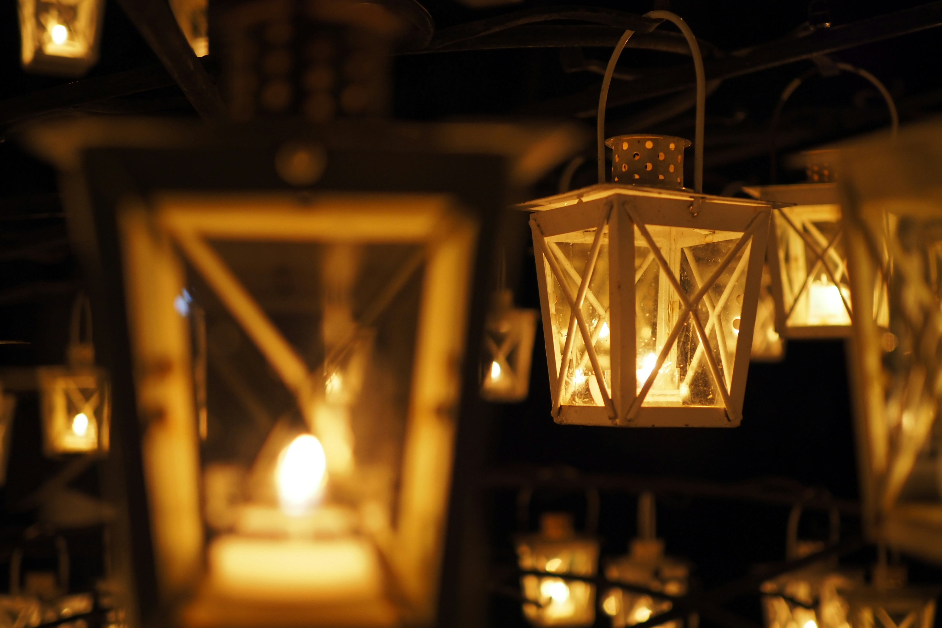 Night scene with hanging lanterns emitting warm light