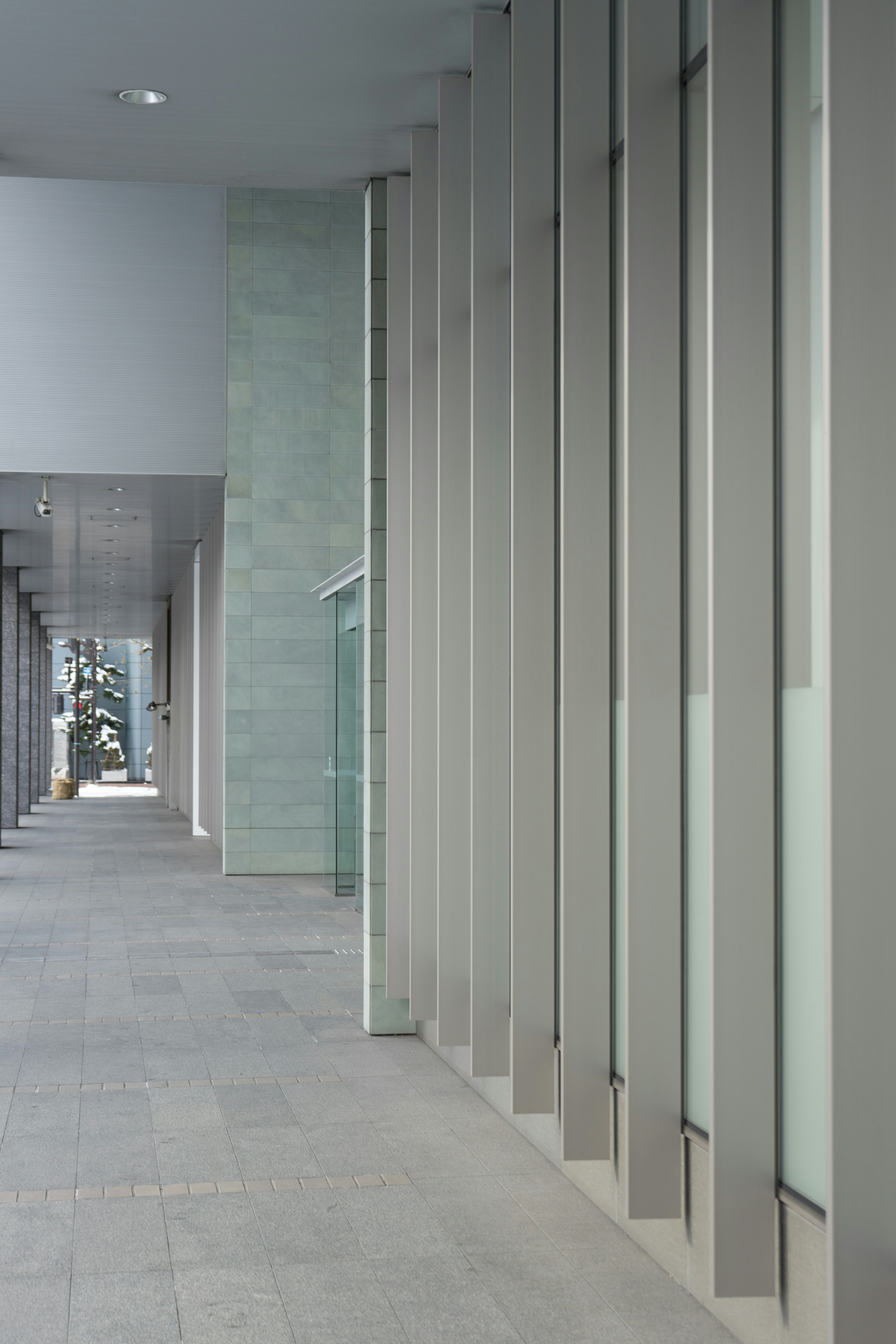 Modern corridor featuring glass and concrete design