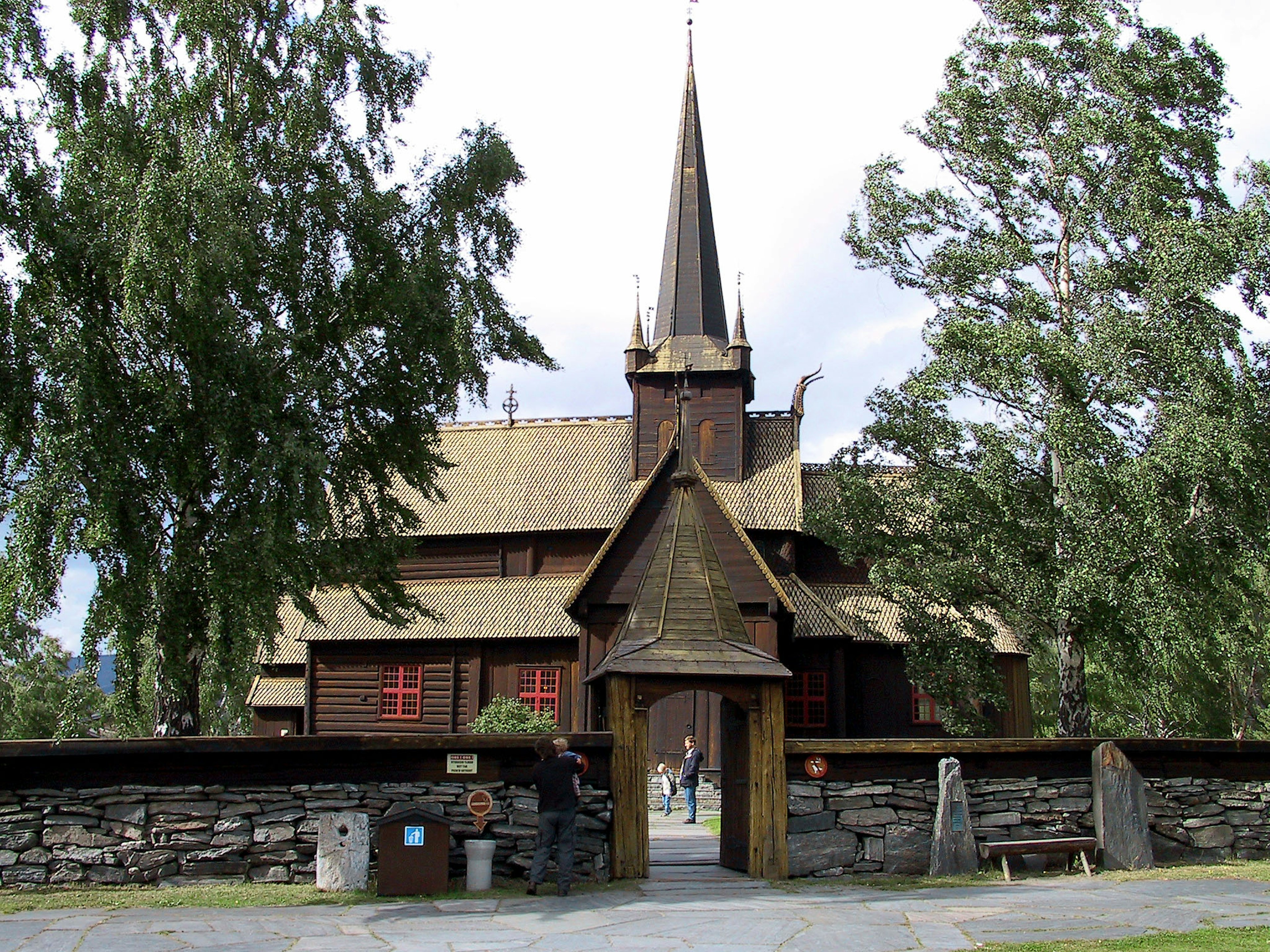 Wooden church exterior featuring a tall spire