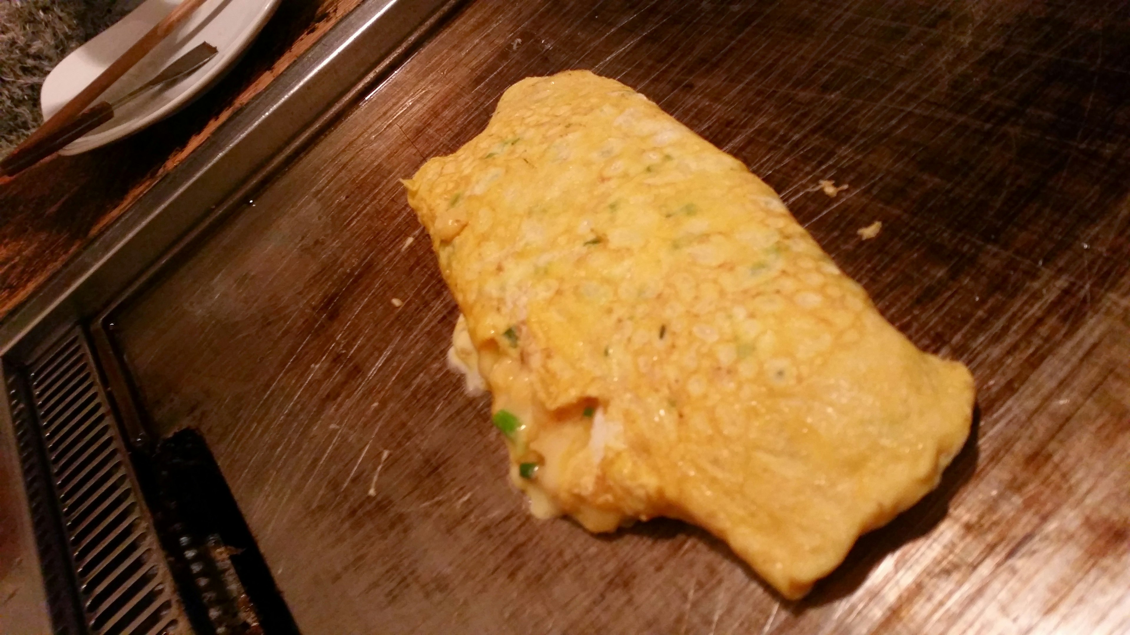 A fluffy omelet on a hot griddle