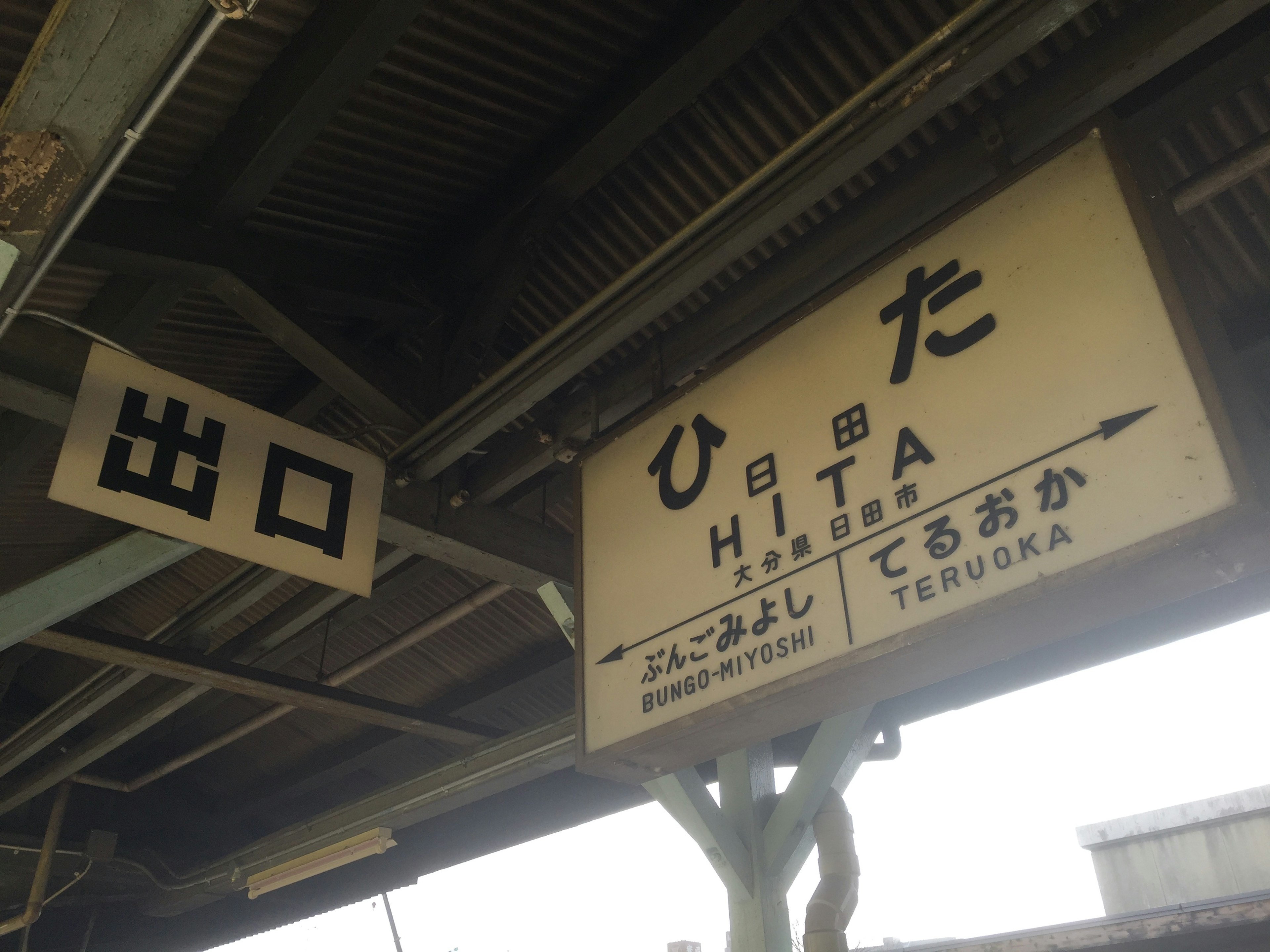 日田駅の駅名看板と出口標識がある駅の内部