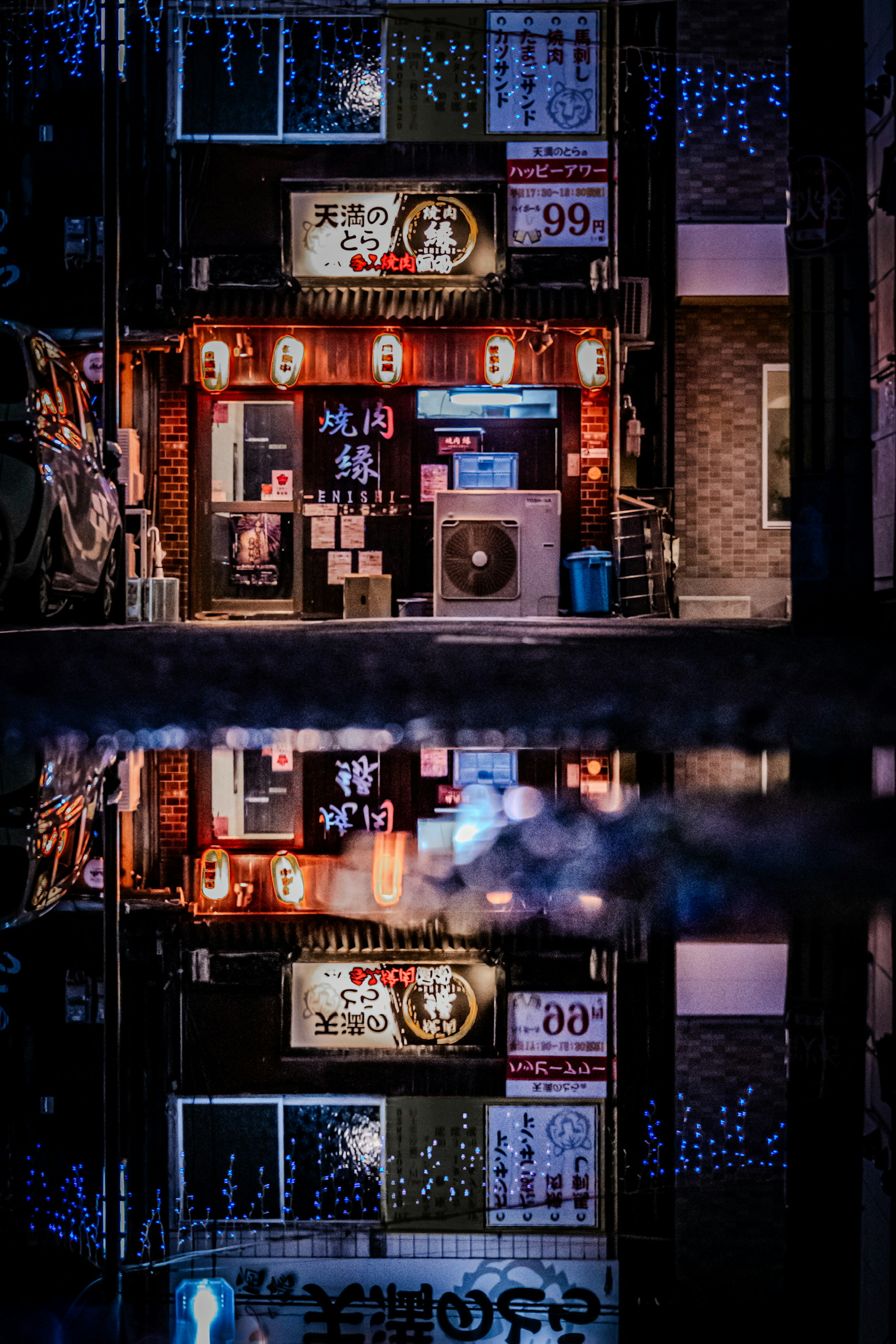 Reflections of a vibrant restaurant with neon lights in a puddle at night