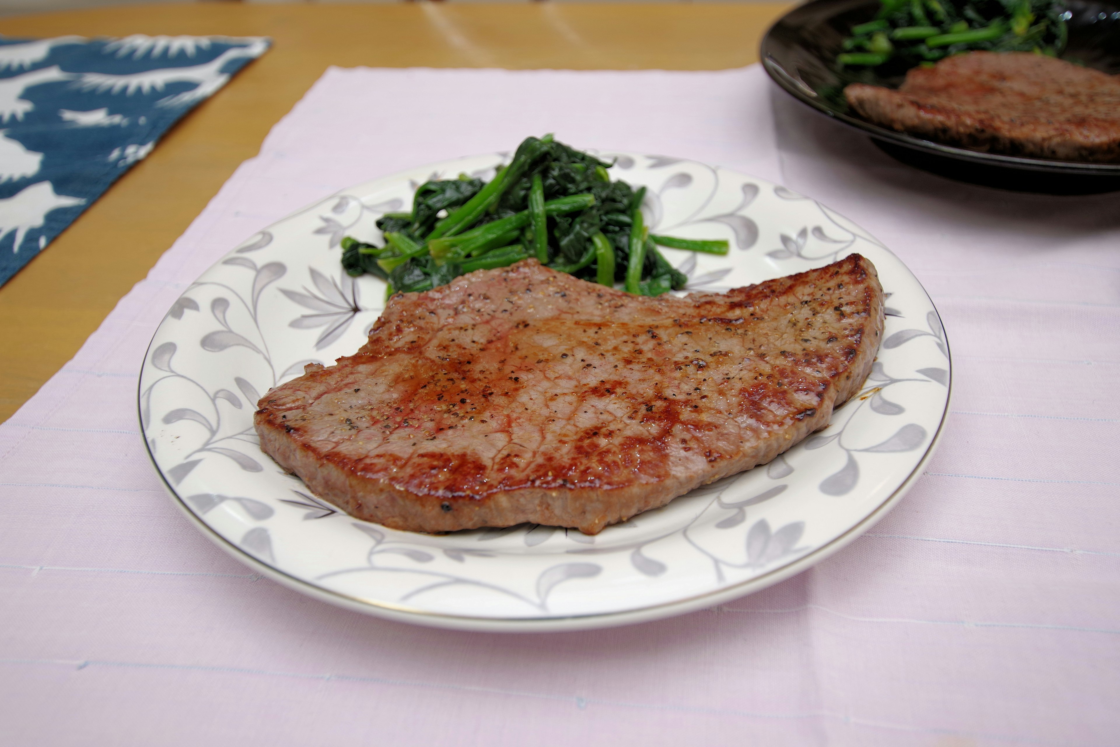 Une assiette avec un morceau de viande grillée et des légumes sautés