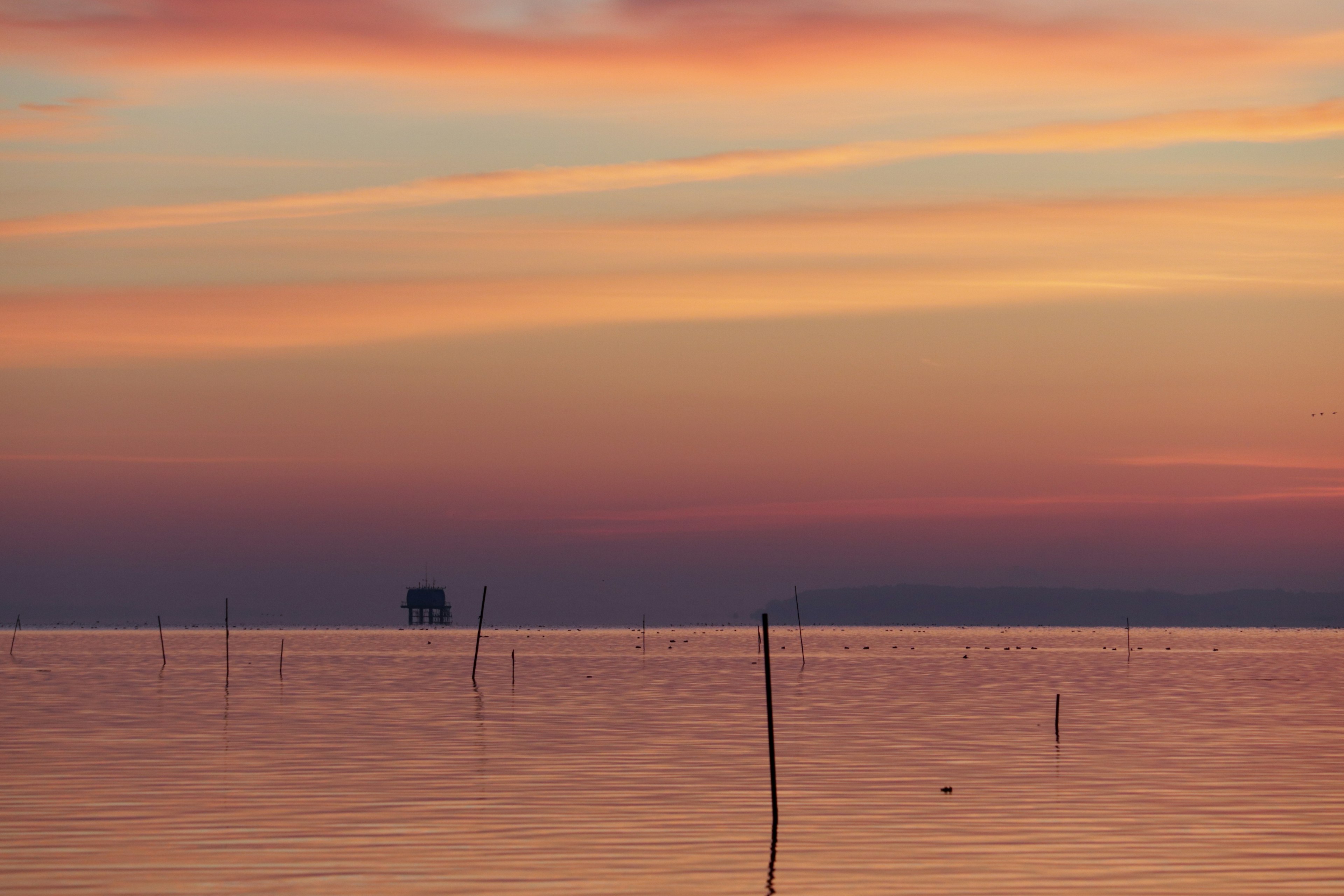 Stunning landscape with sunset sky and calm water surface