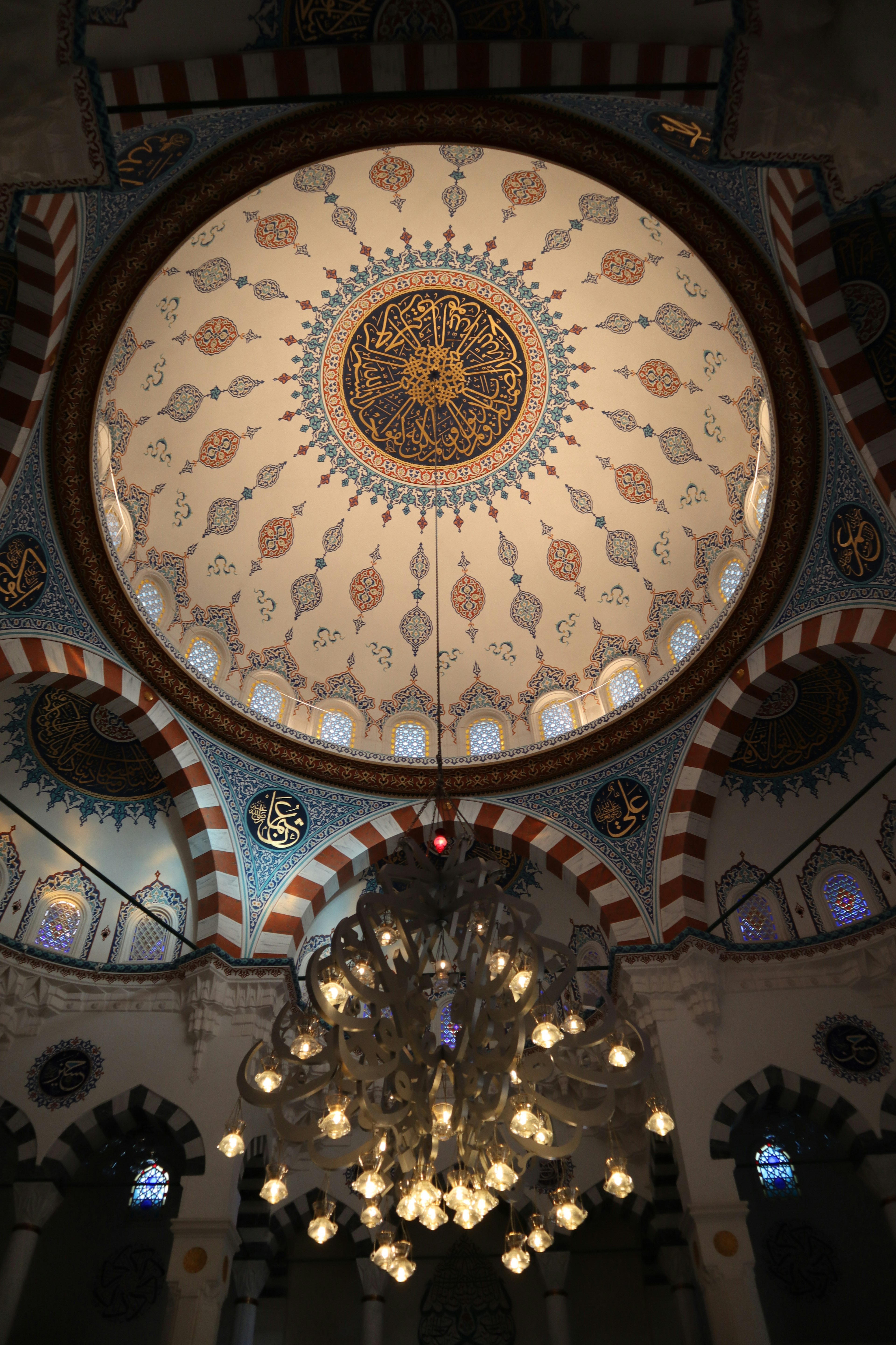 Intricate dome ceiling with an ornate chandelier