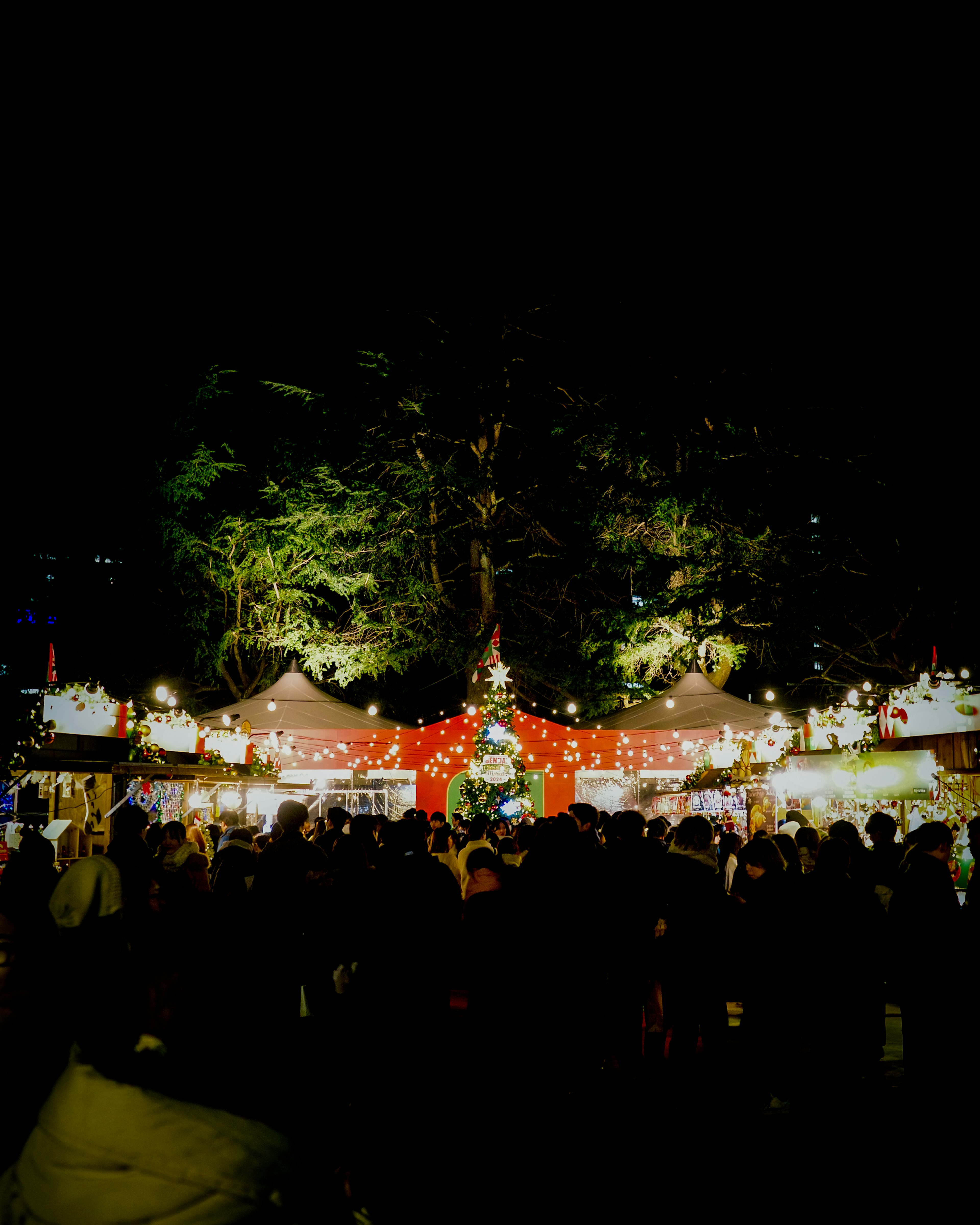 Night festival with bustling stalls and bright lights