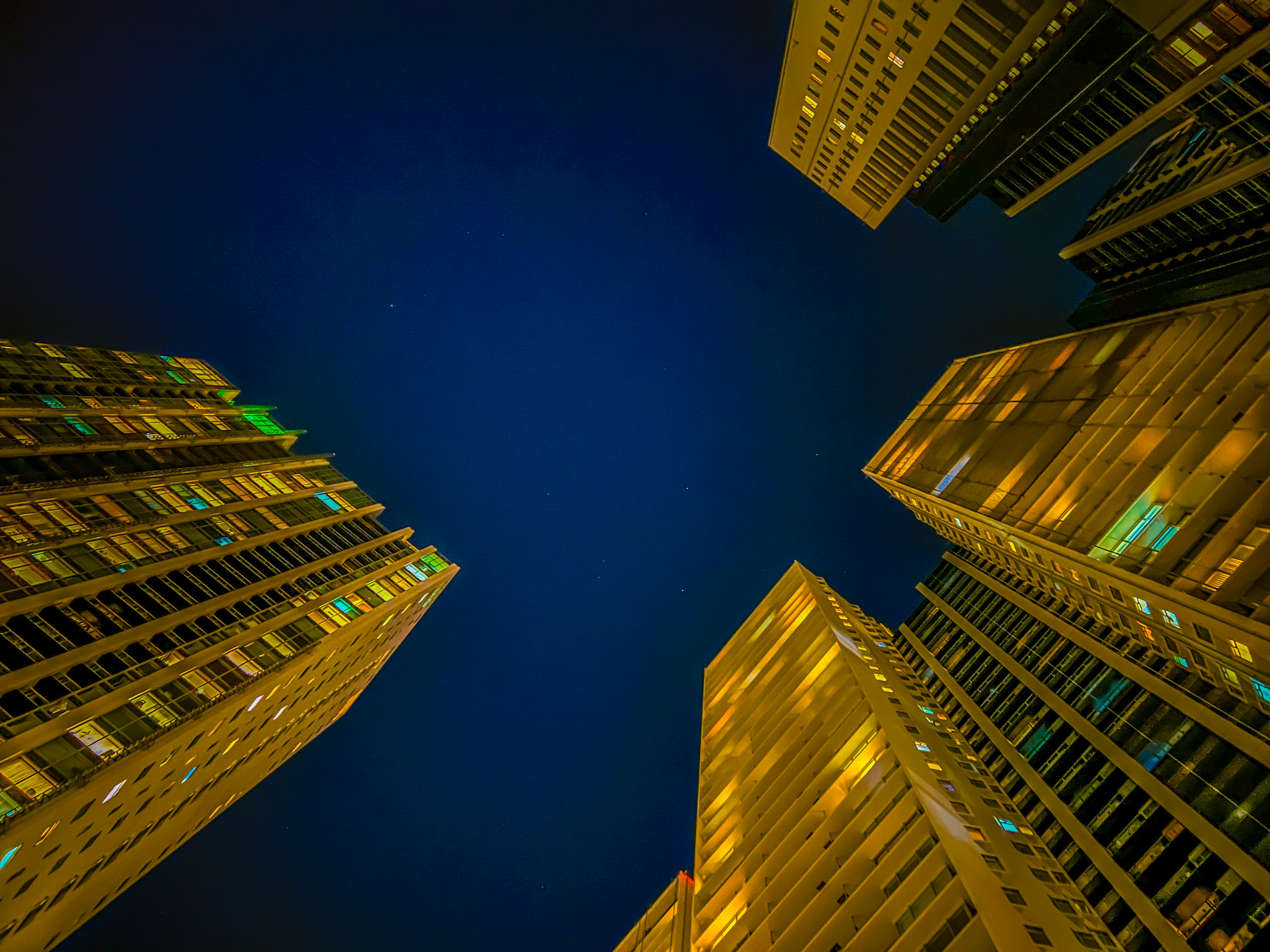 View of towering buildings against a night sky