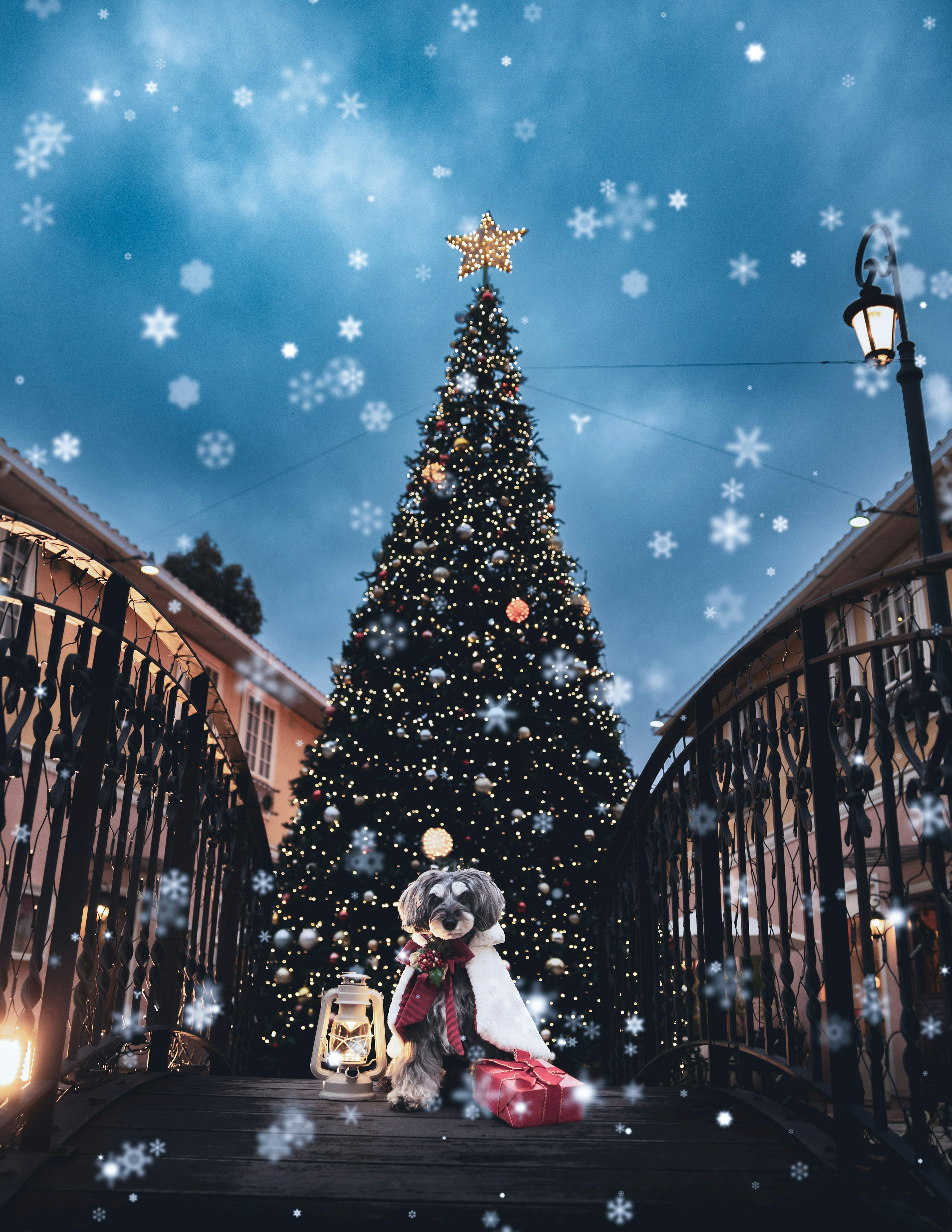 A sparkling Christmas tree with decorations under falling snow at night