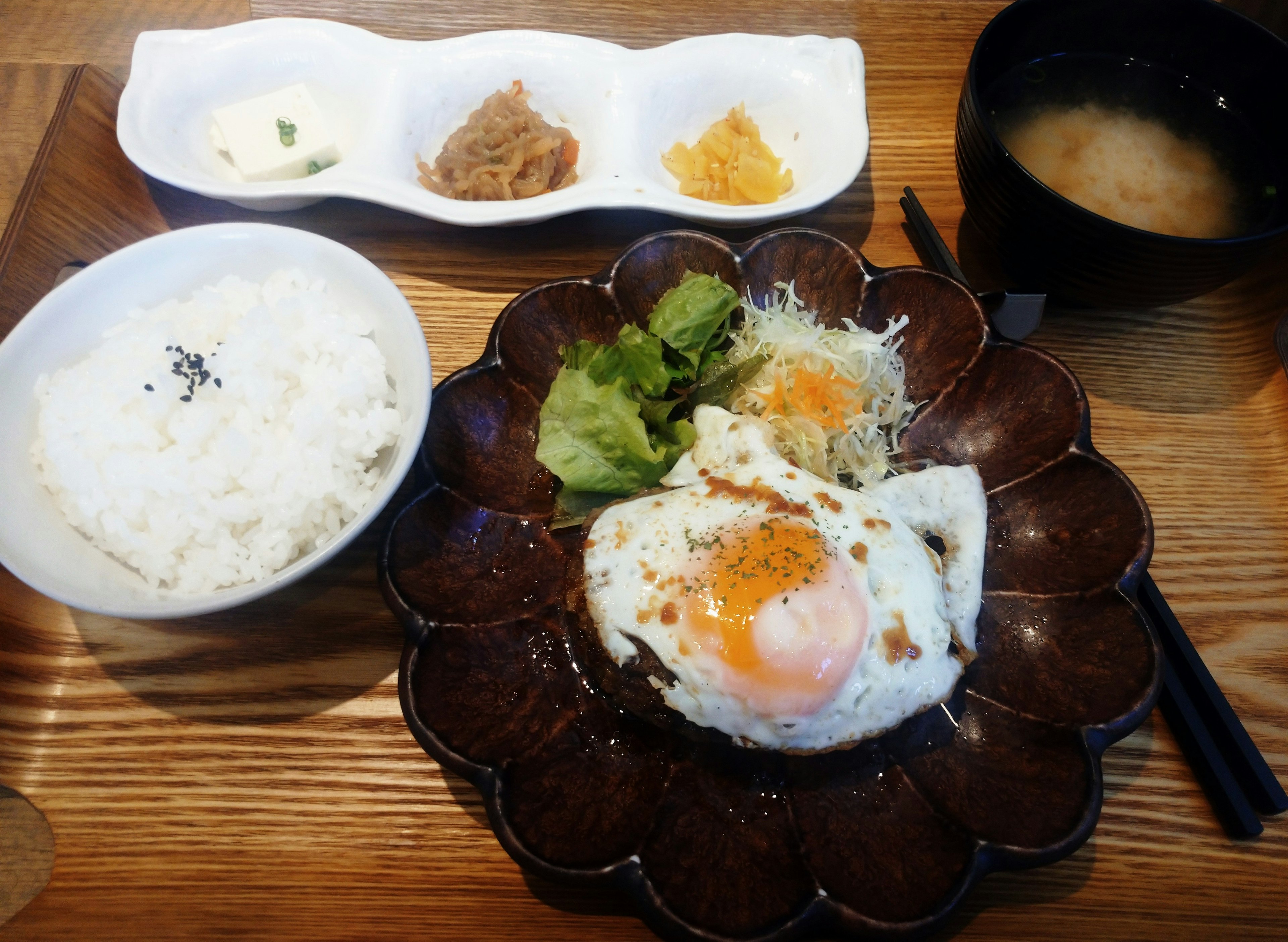 Rice, onsen egg, vegetable salad, miso soup, Japanese style presentation