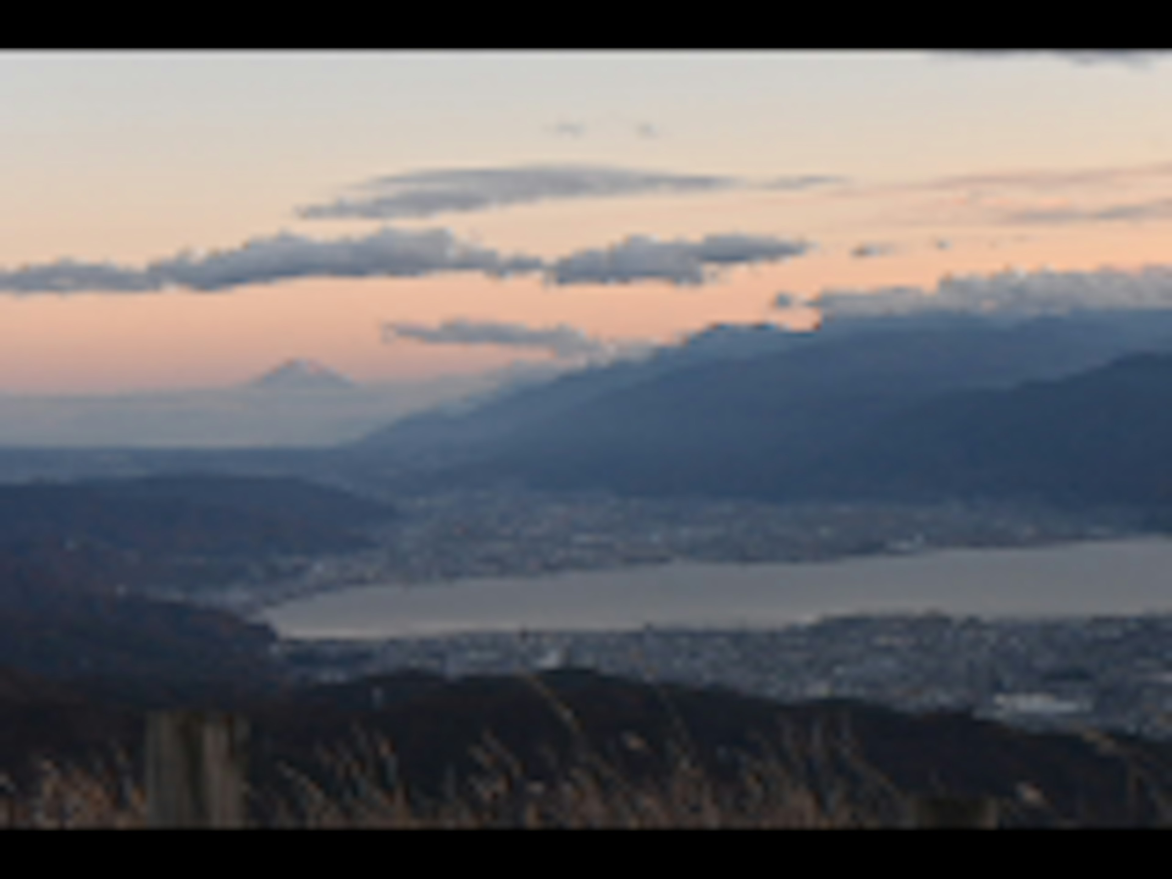 Scenic view of Mount Fuji at sunset with mountains and a lake