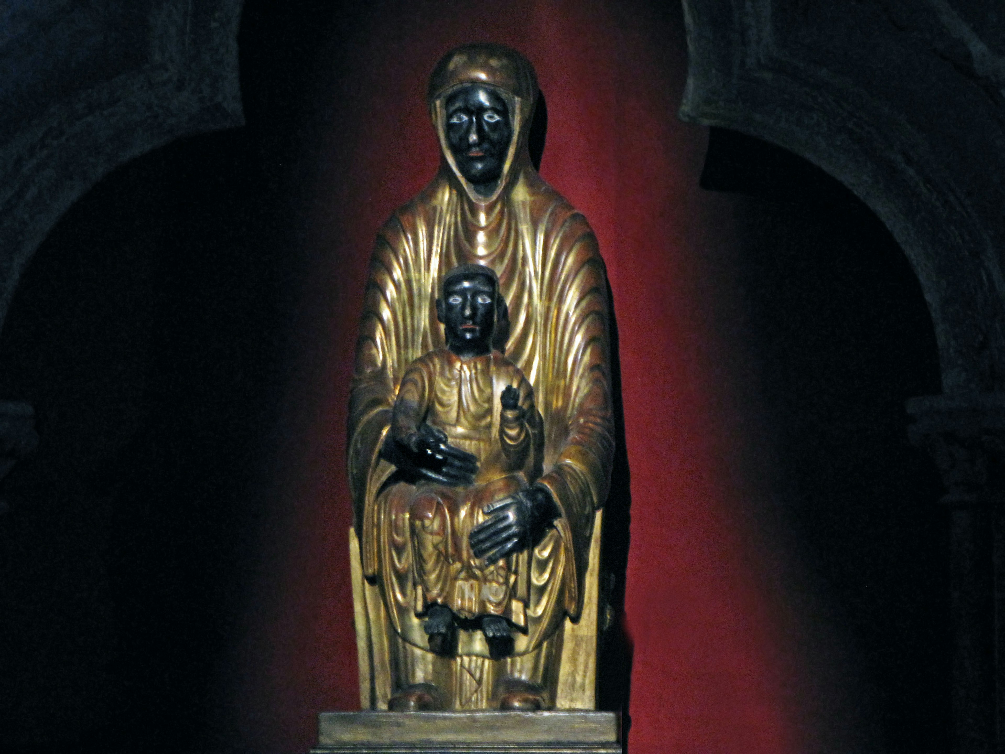 Black Madonna statue dressed in golden robes holding a child