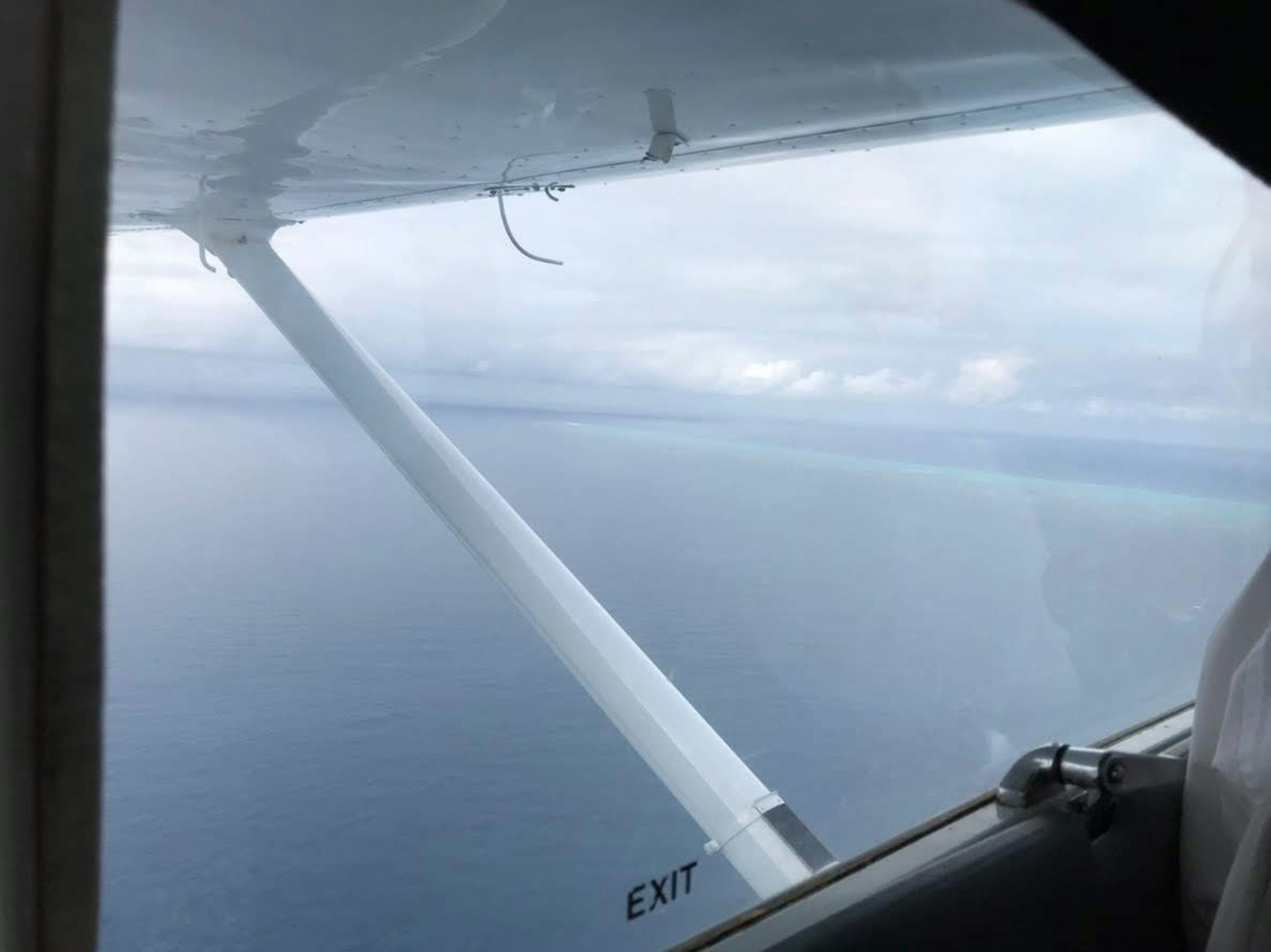 View of the ocean and sky from an airplane window