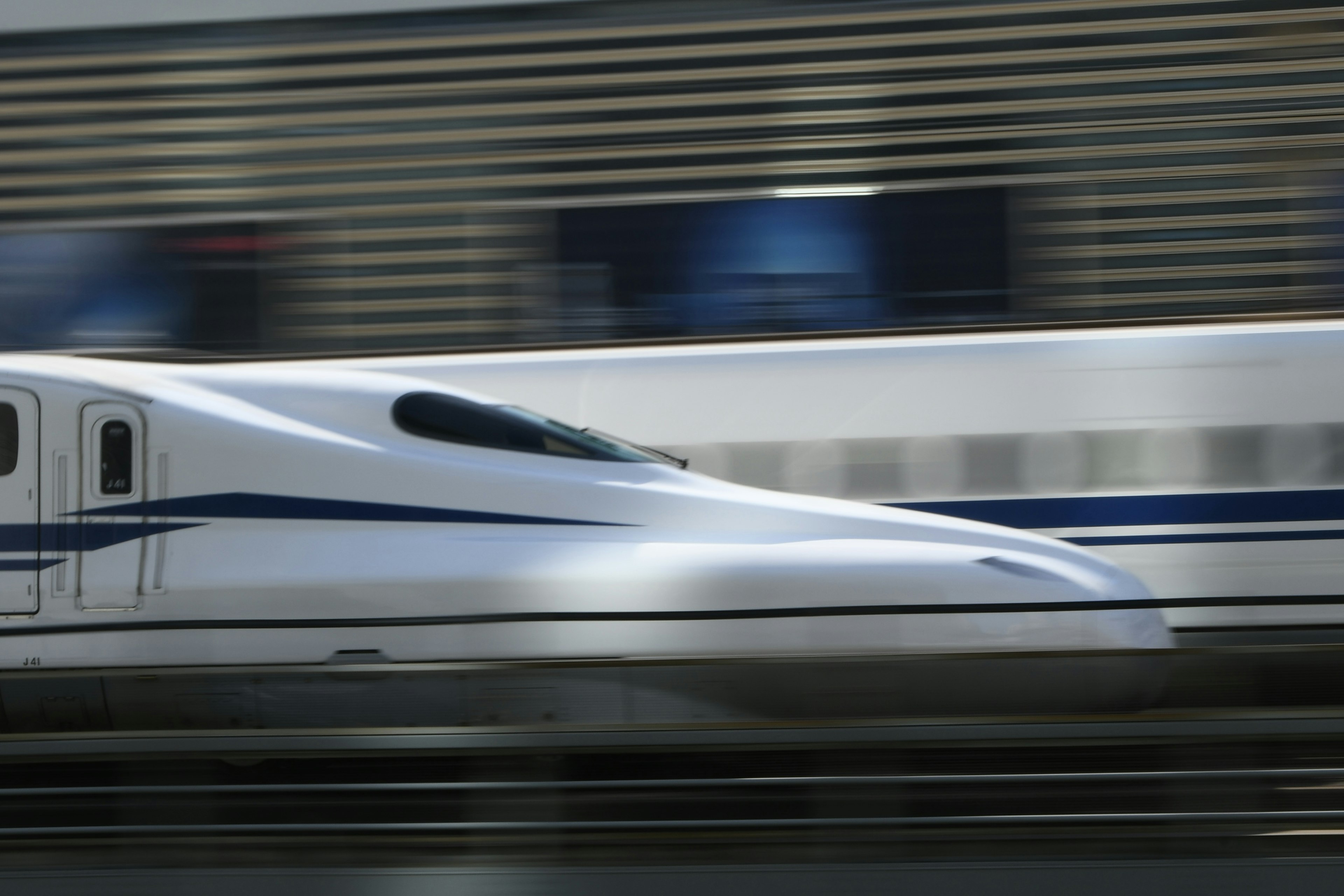 Shinkansen train in motion showcasing speed and sleek design