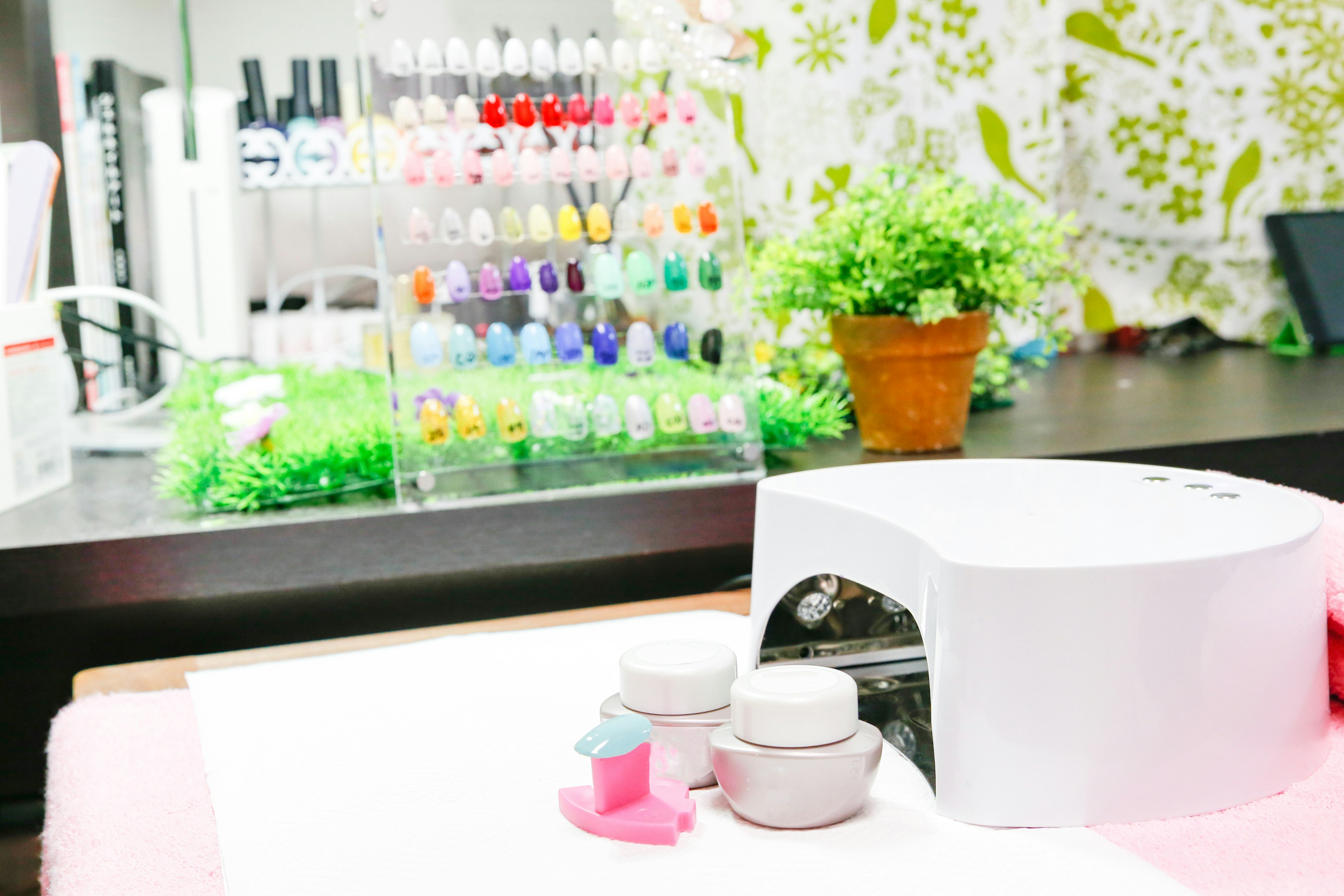 Interior of a nail salon featuring a colorful display of nail polishes and a manicure station