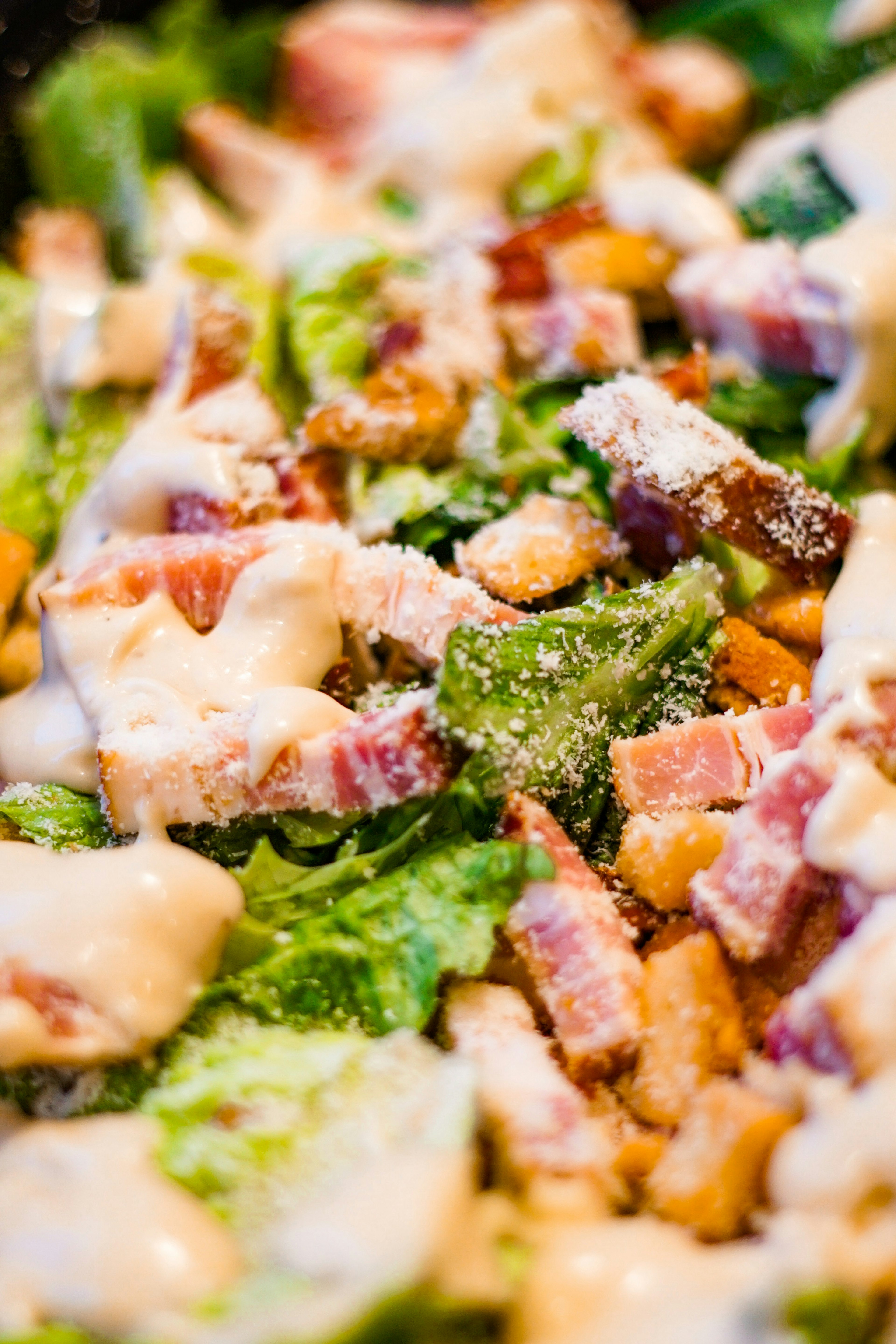 Fresh lettuce and bacon salad topped with creamy dressing