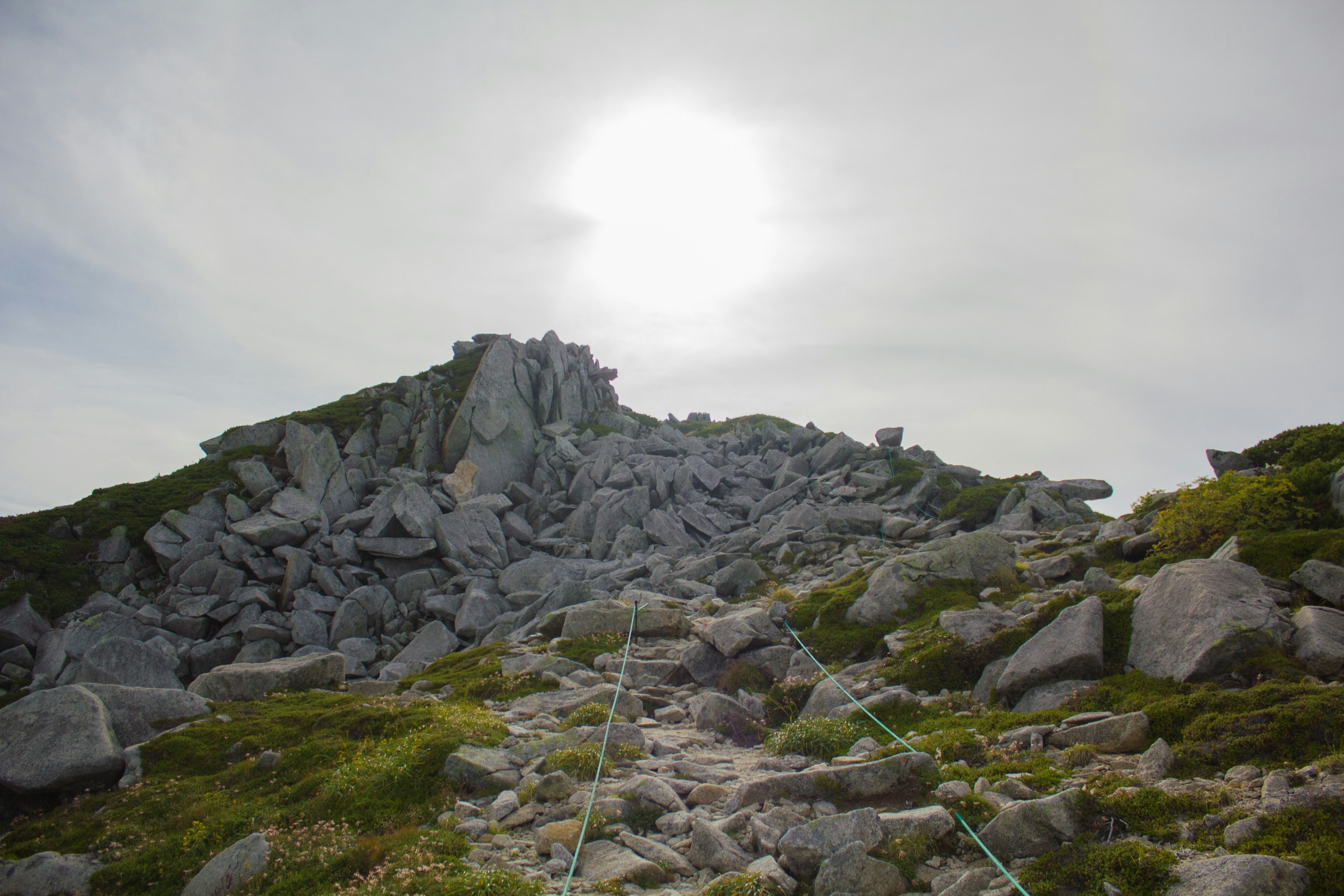 Mountain landscape with scattered rocks and sunlight