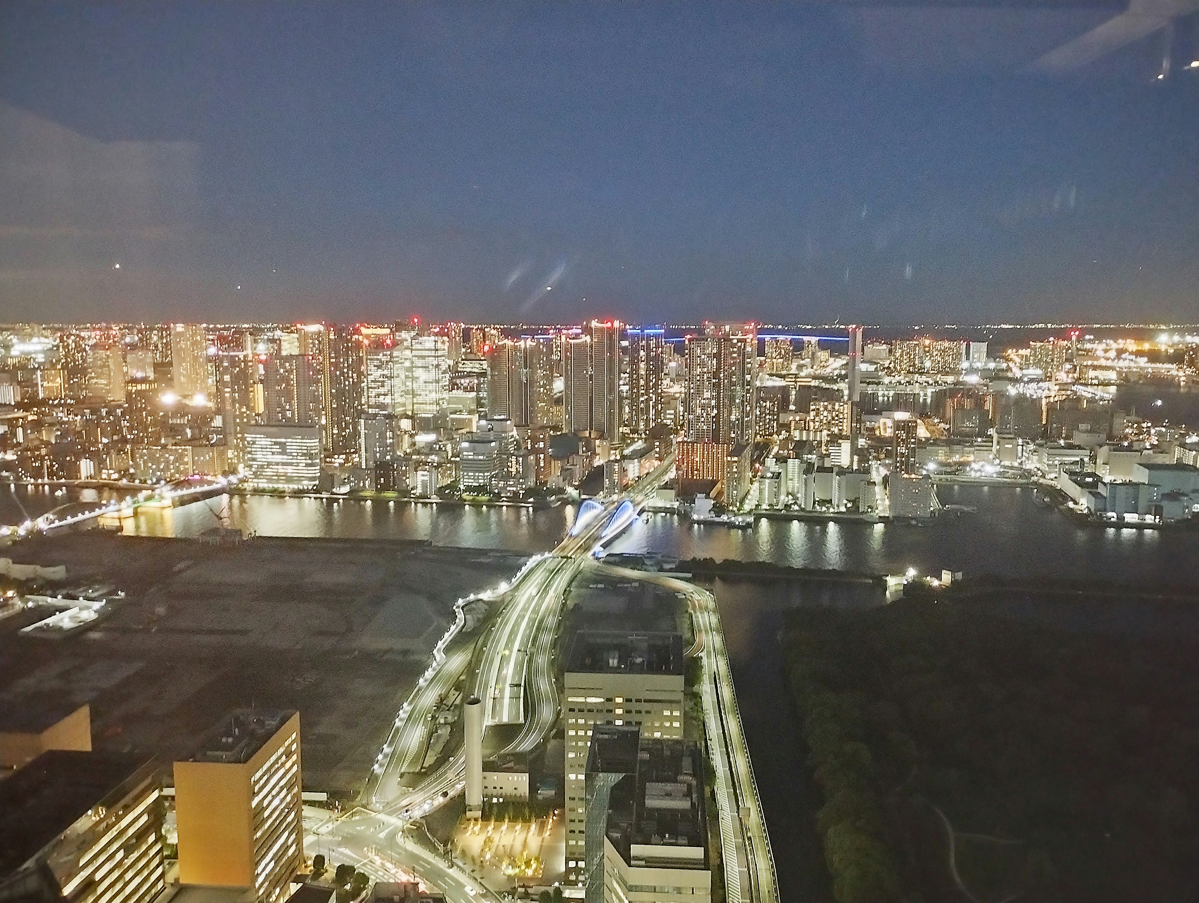 Panoramic view of Tokyo Bay at night with illuminated skyscrapers