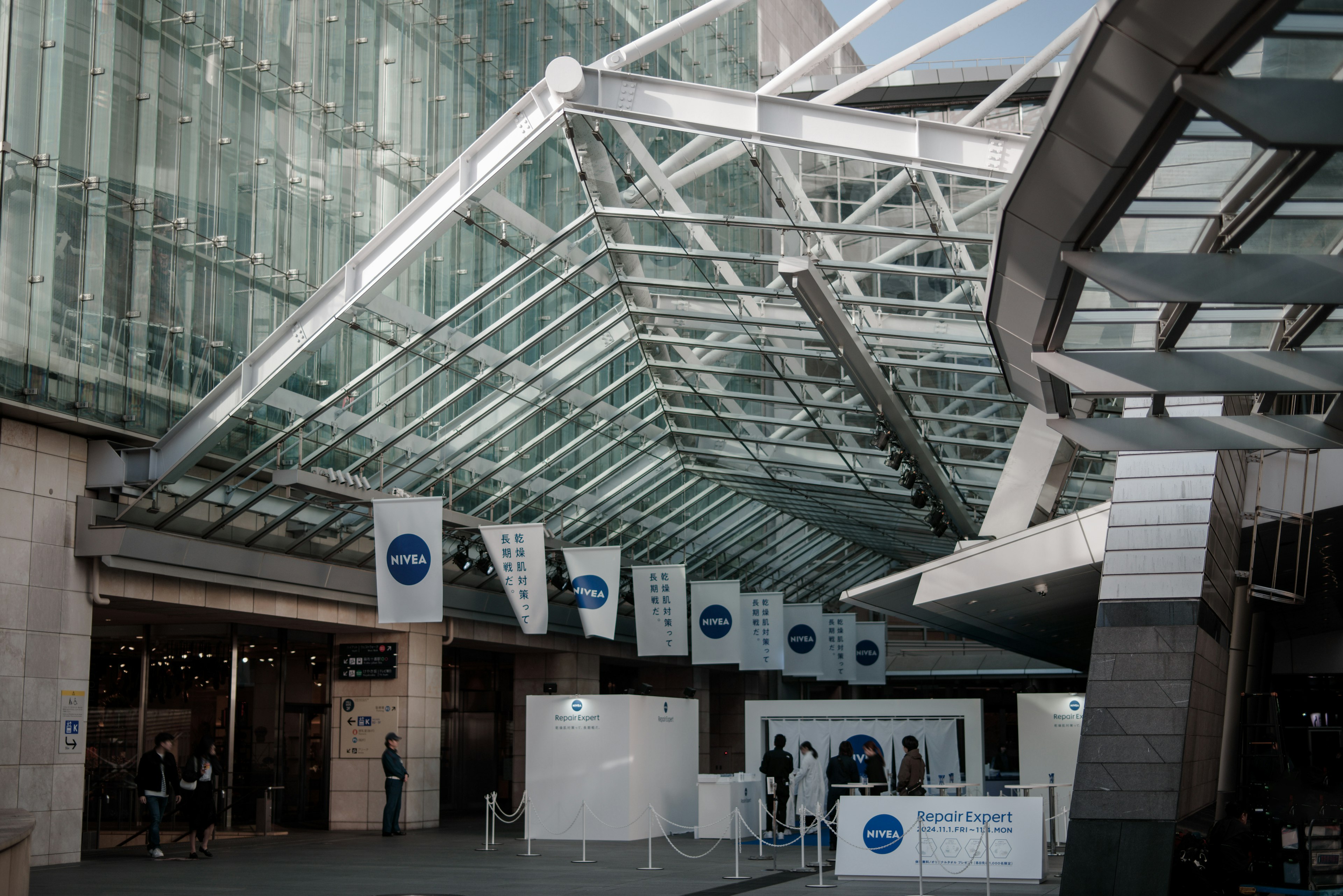 Modern entrance hall with a glass roof and banners