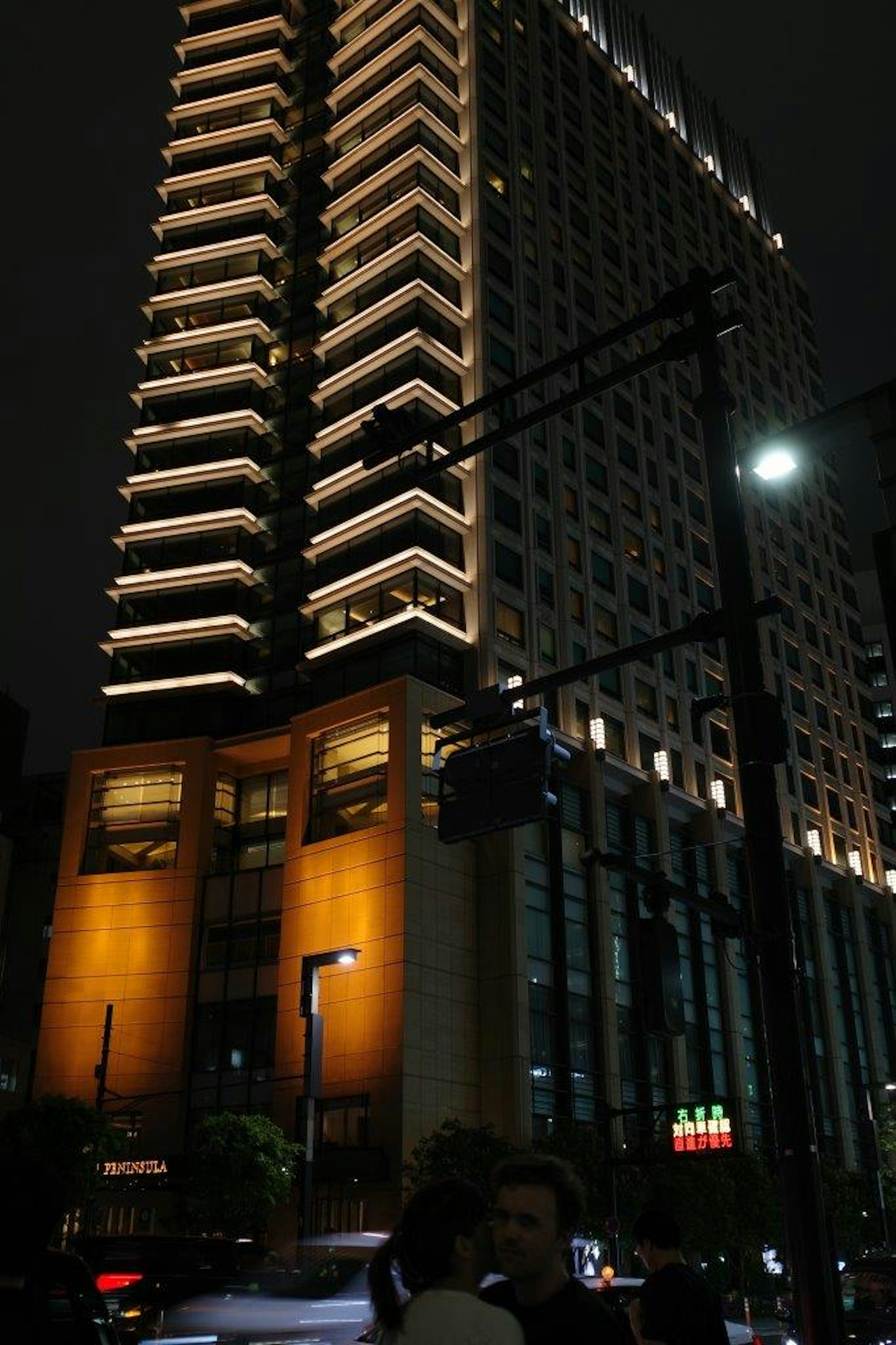 Exterior view of a high-rise building at night with illuminated features