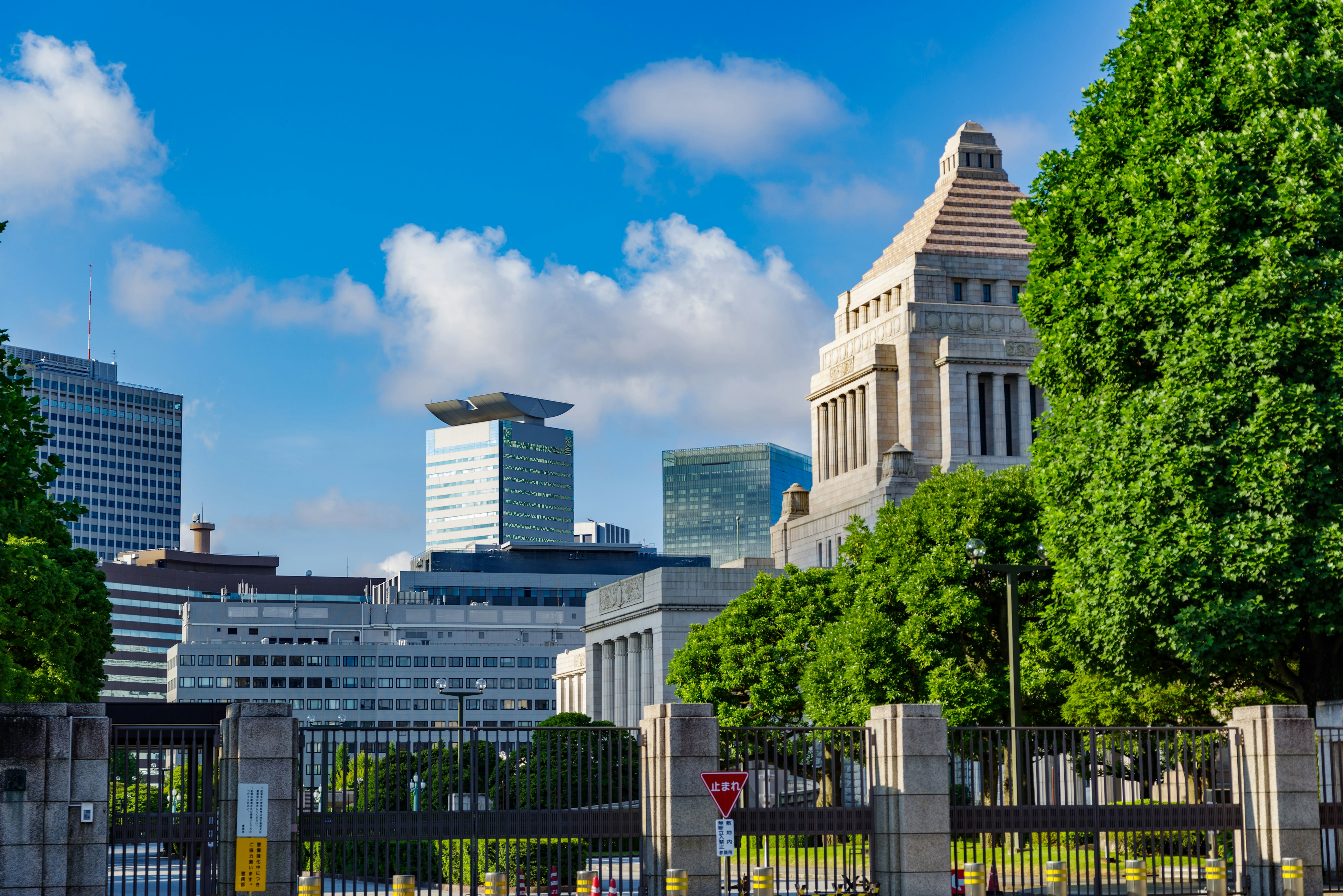 Modern buildings and lush green trees in a Tokyo cityscape