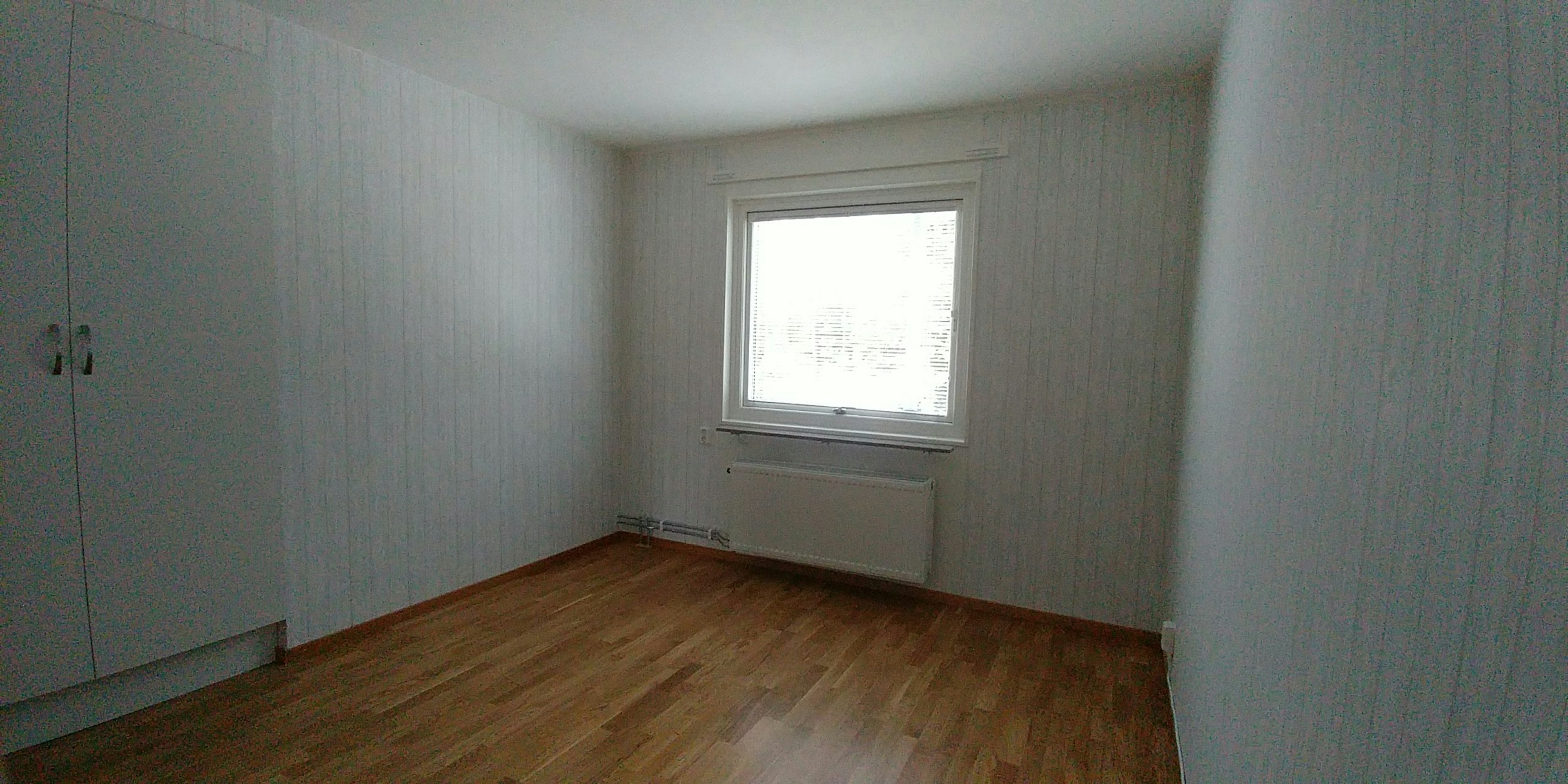 Bright room with a window and wooden floor