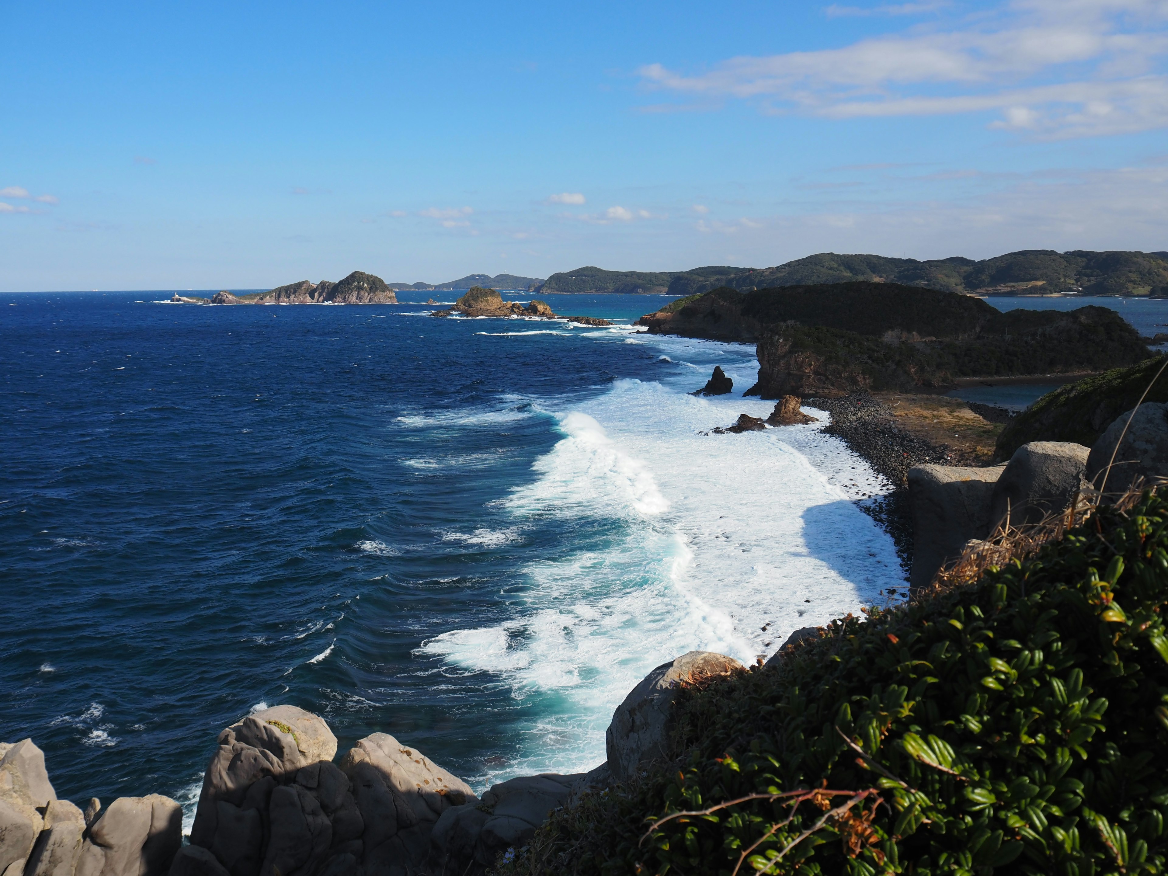 Coastal landscape with blue ocean and white waves